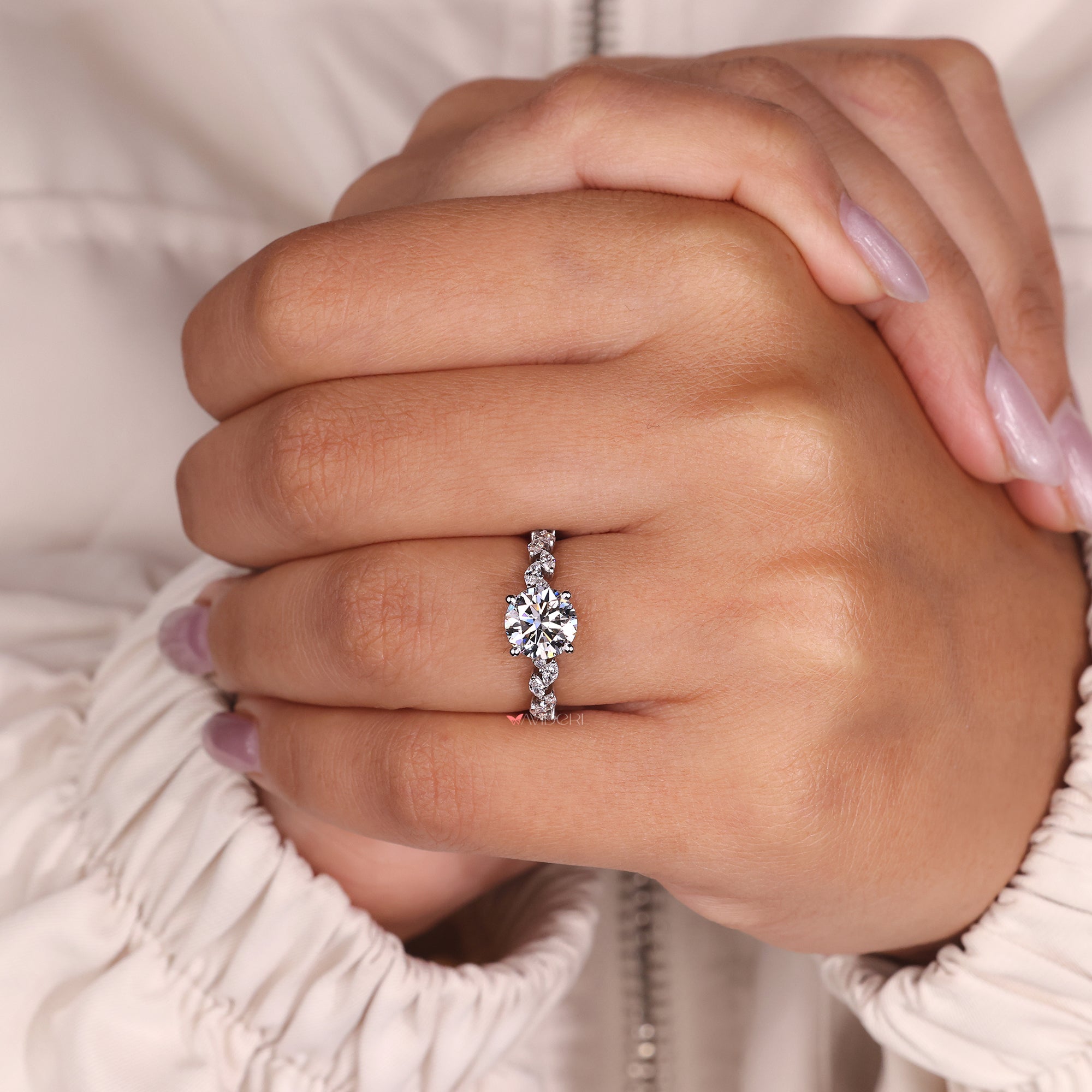 Anniversary gifts for her include this round diamond ring, set in a white gold pave band.