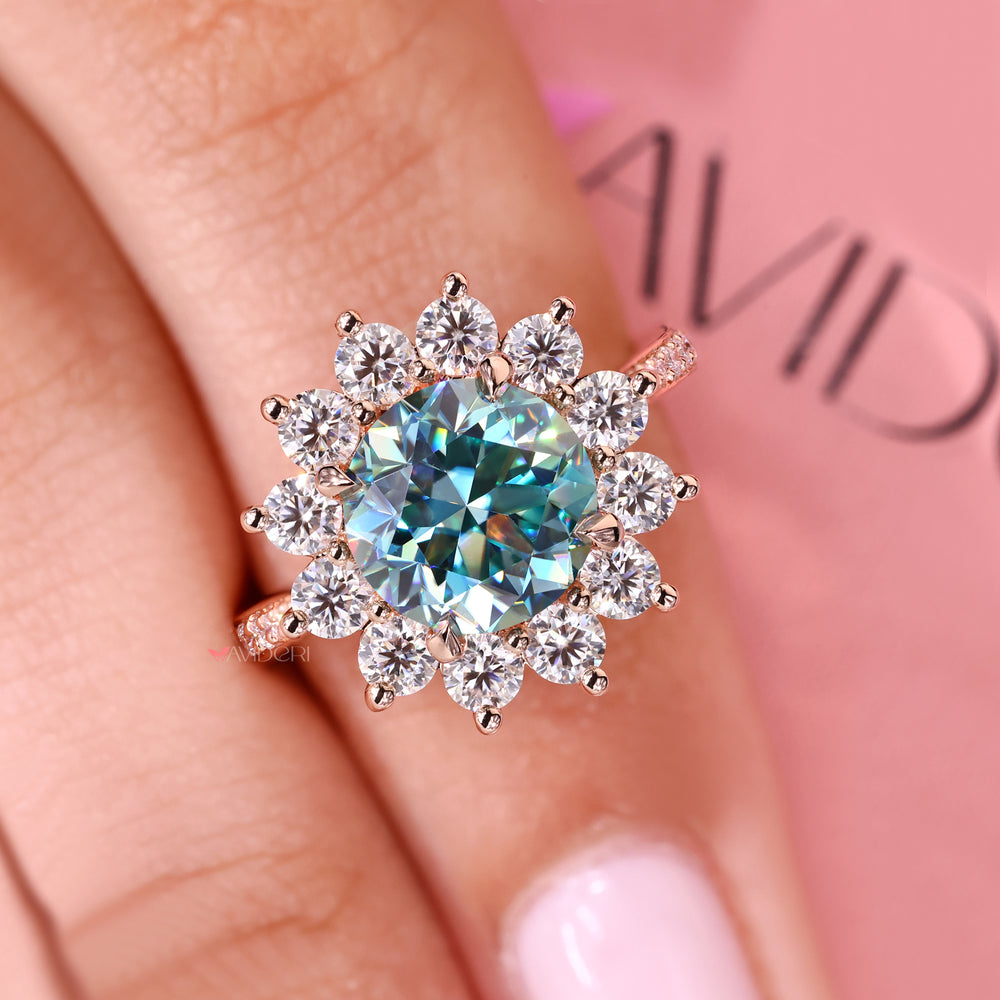 Cyan blue moissanite cluster ring with round stones.
