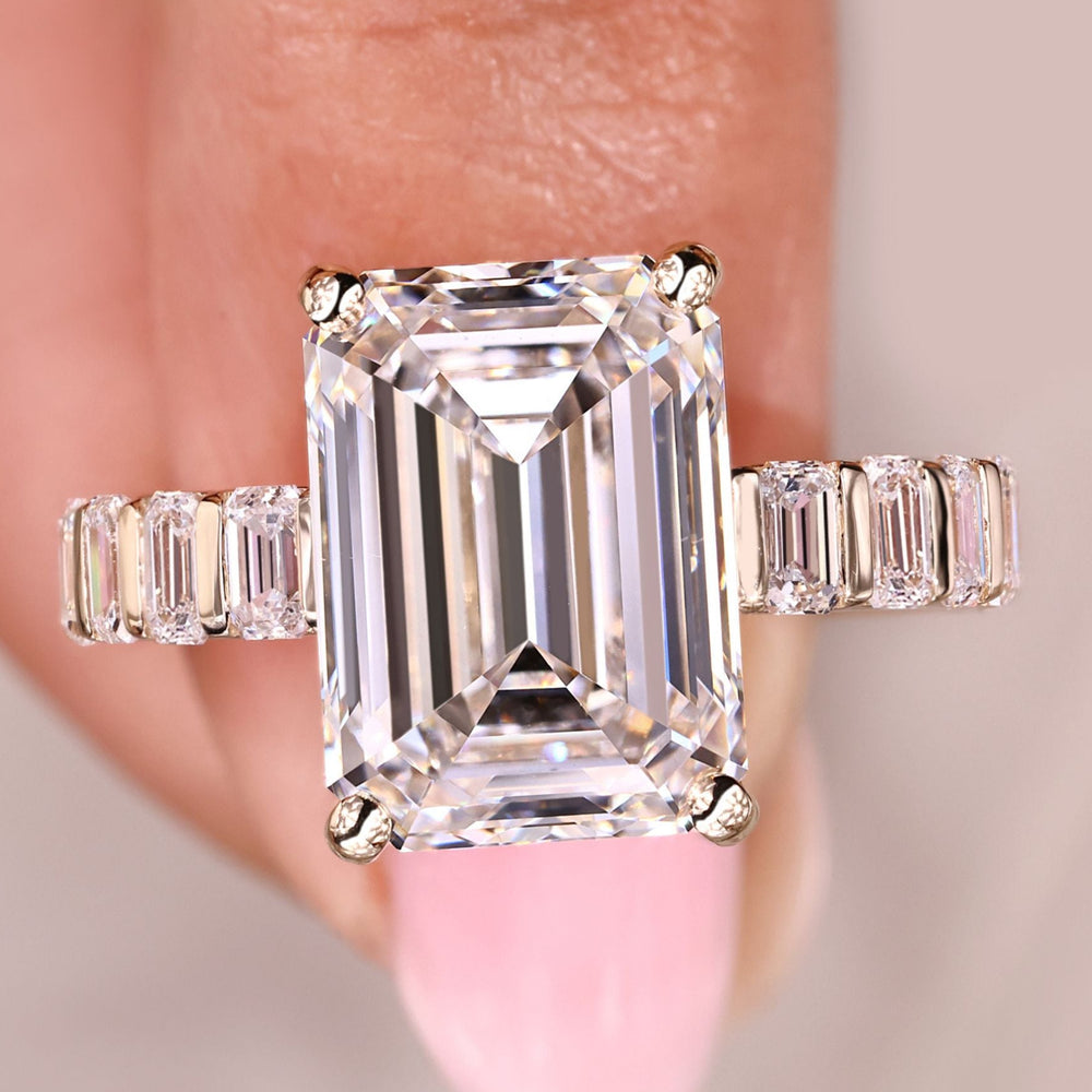 Emerald cut ring with emerald pave band and four prongs.
