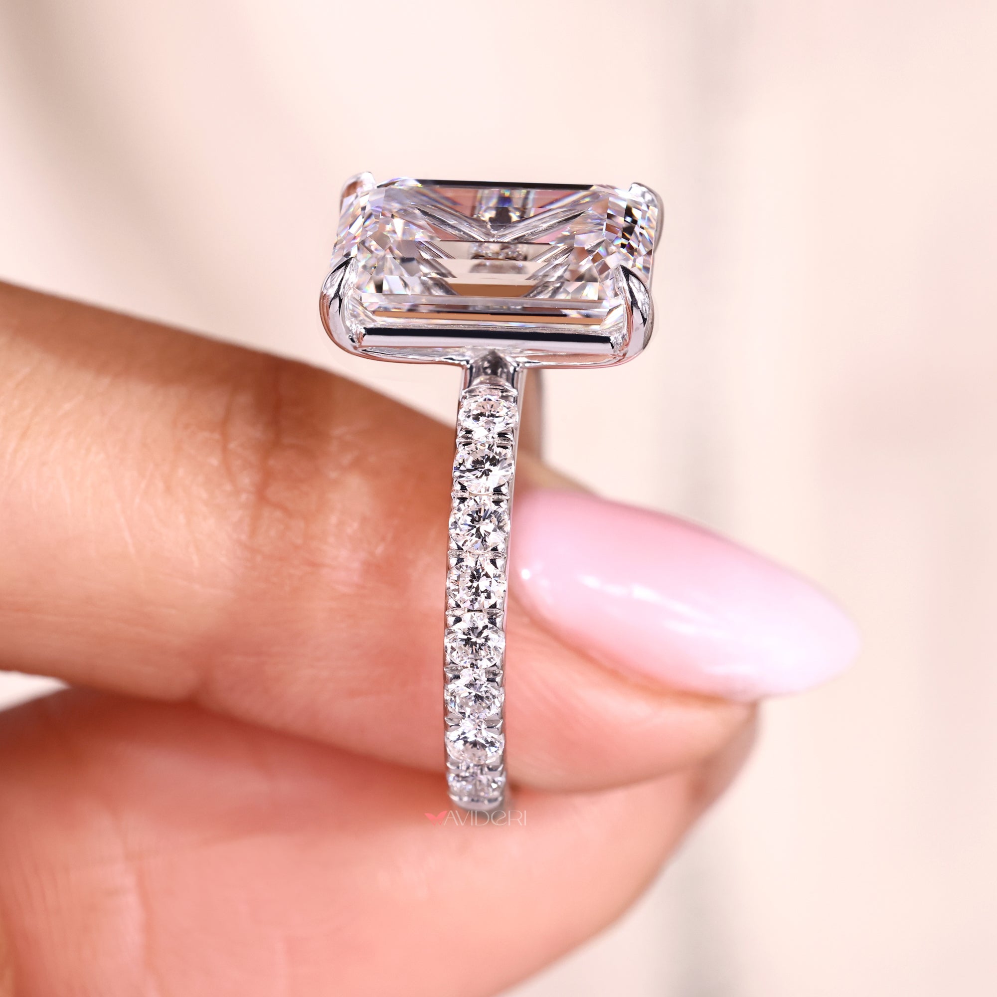 Pave emerald cut diamond ring with round diamonds.
