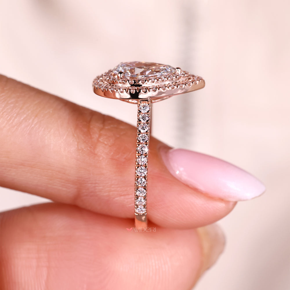 Pave setting ring with pear center stone.