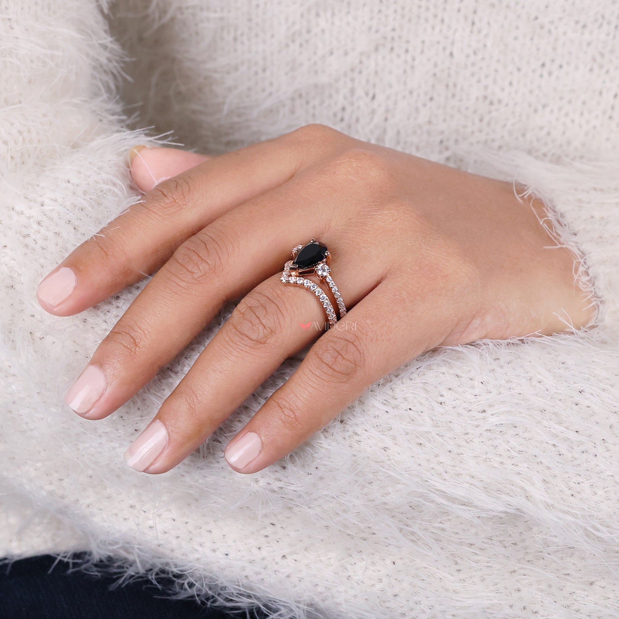 V shape band with a pear shaped center stone for a distinctive look.