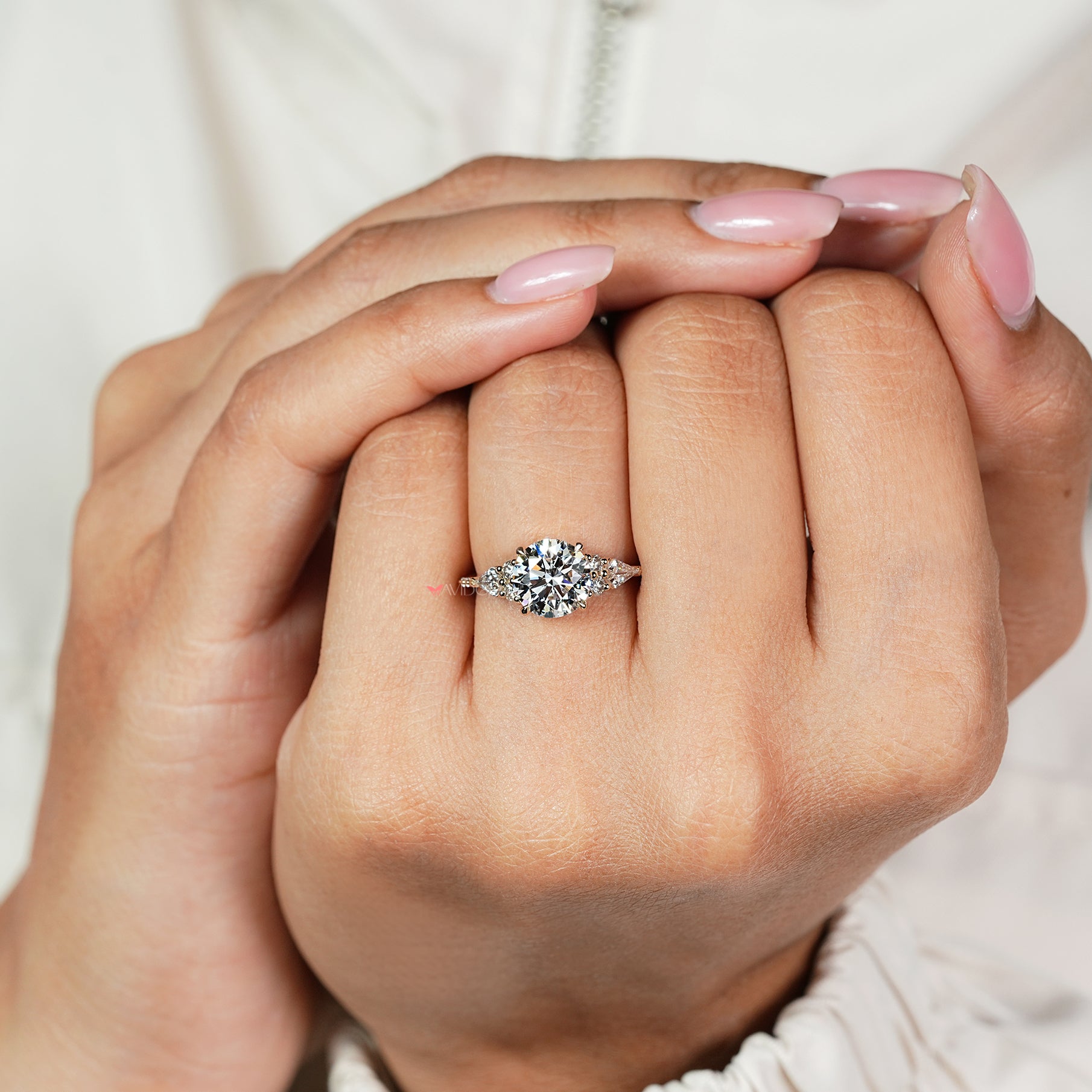 IGI certified round diamond ring with four claw prongs
