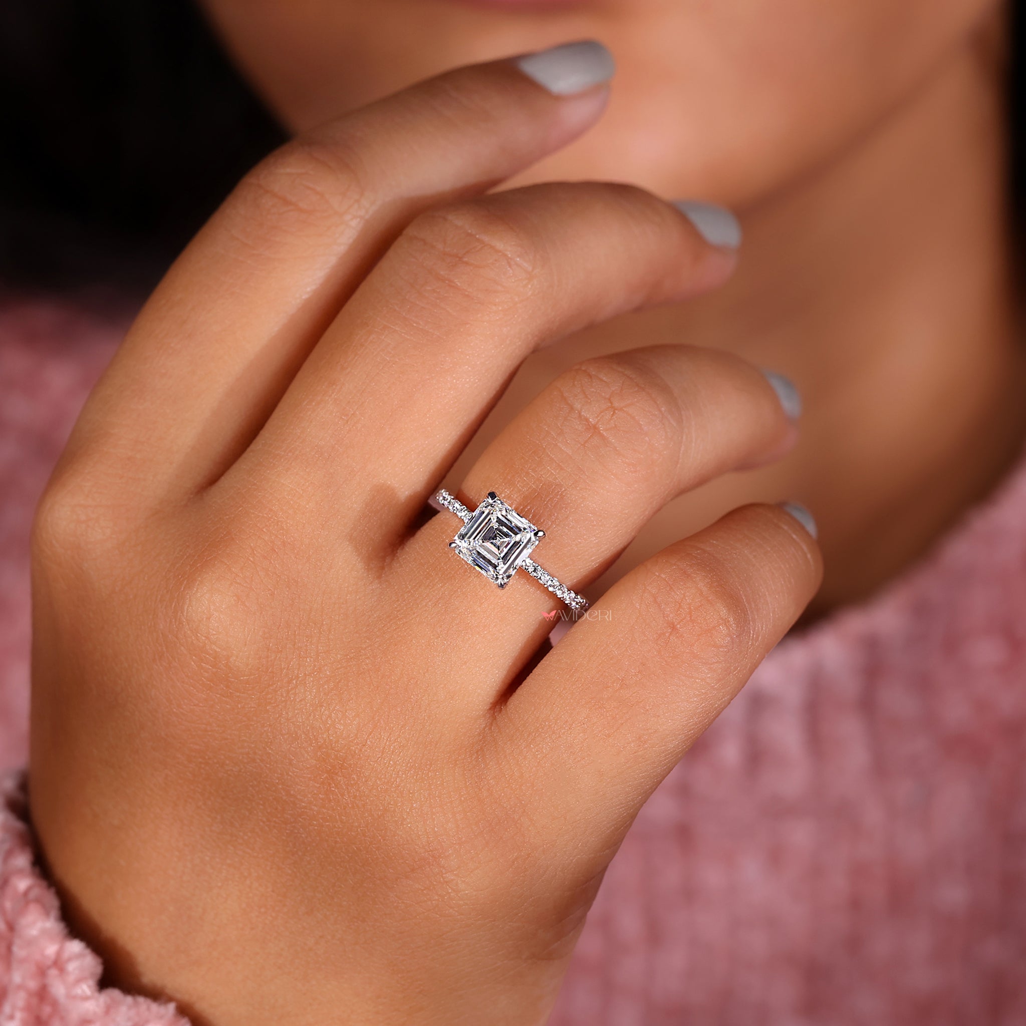 Lab grown asscher cut diamond ring with four claw prongs.
