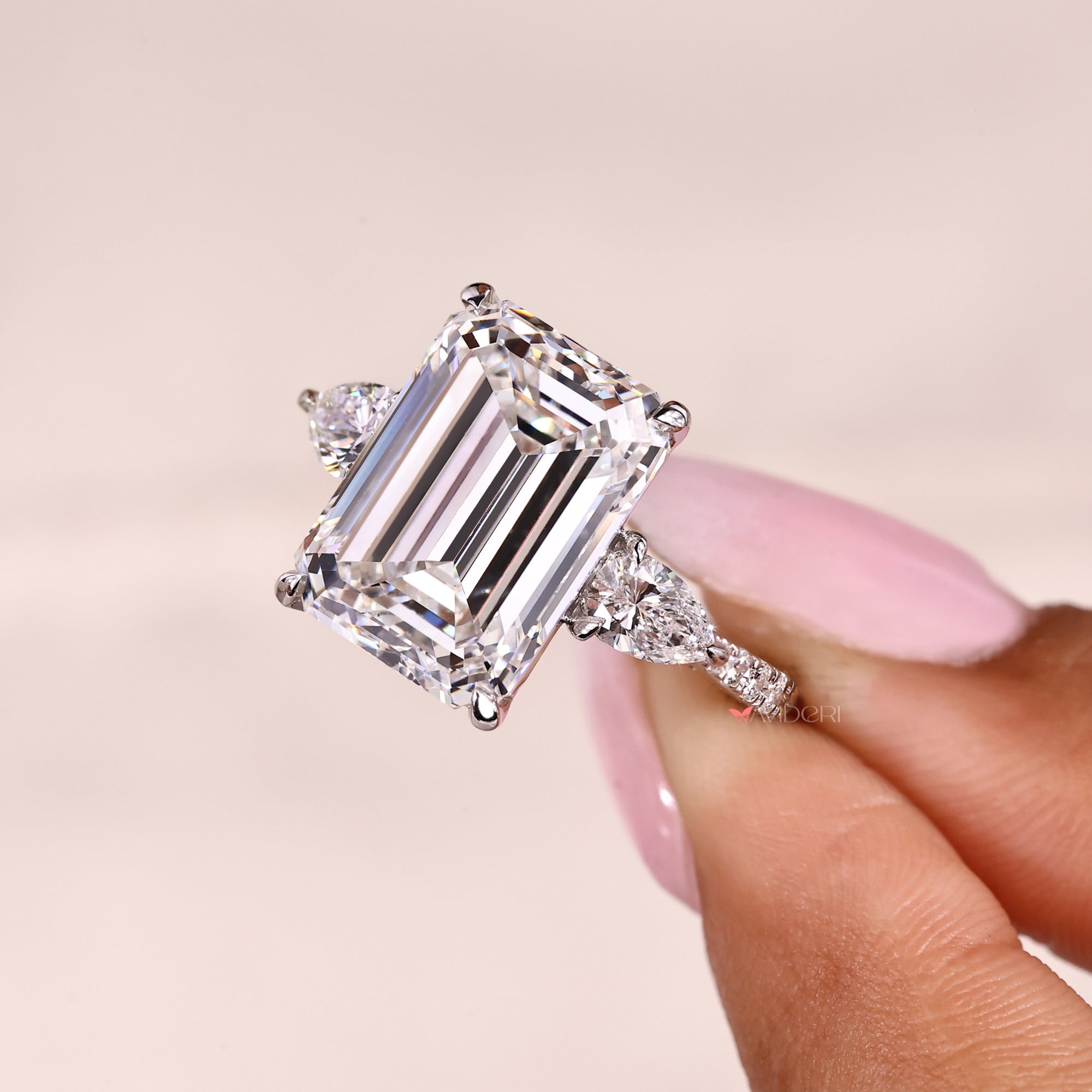 Lab grown emerald cut diamond ring with tapered shank.
