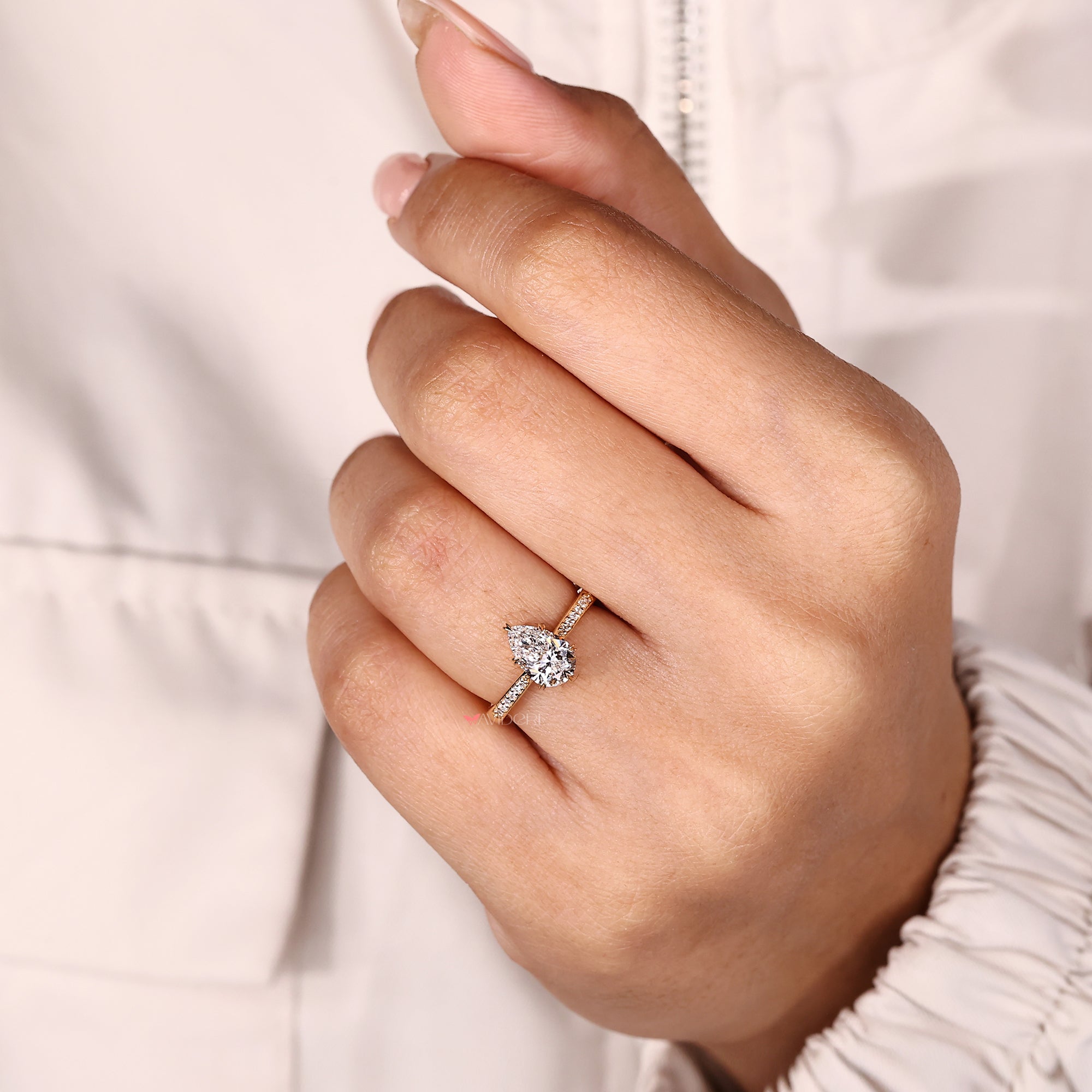 Lab grown pear diamond ring with cathedral setting.
