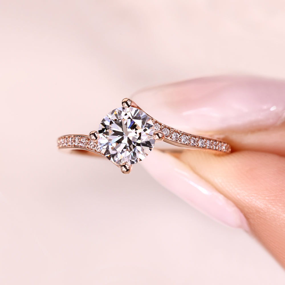 Modern round diamond ring with pave accents.

