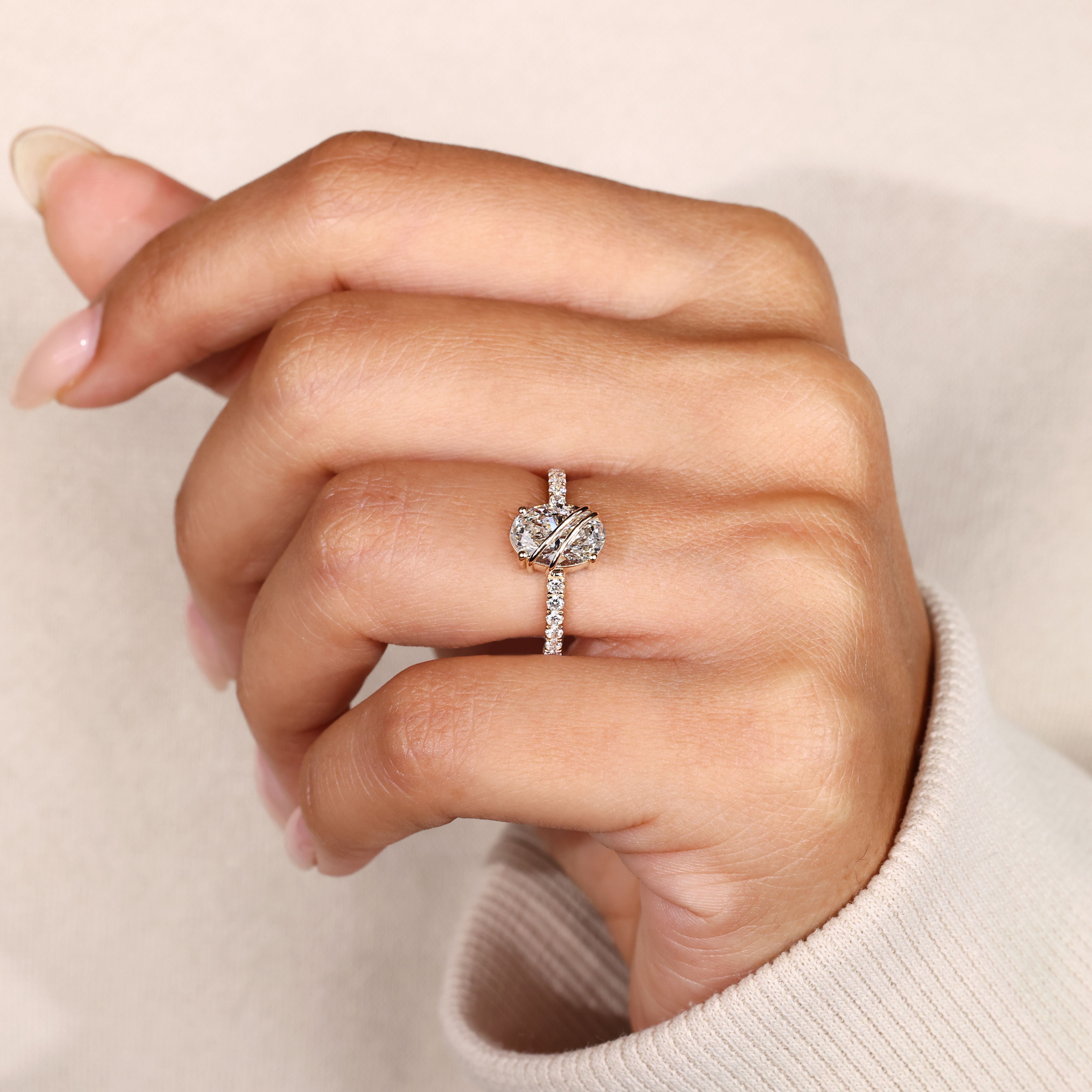 Lab grown oval diamond ring with pave detailing.
