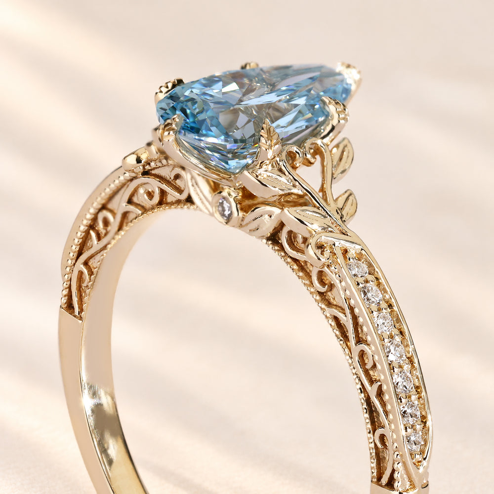 Nature inspired blue pear diamond ring with pave.
