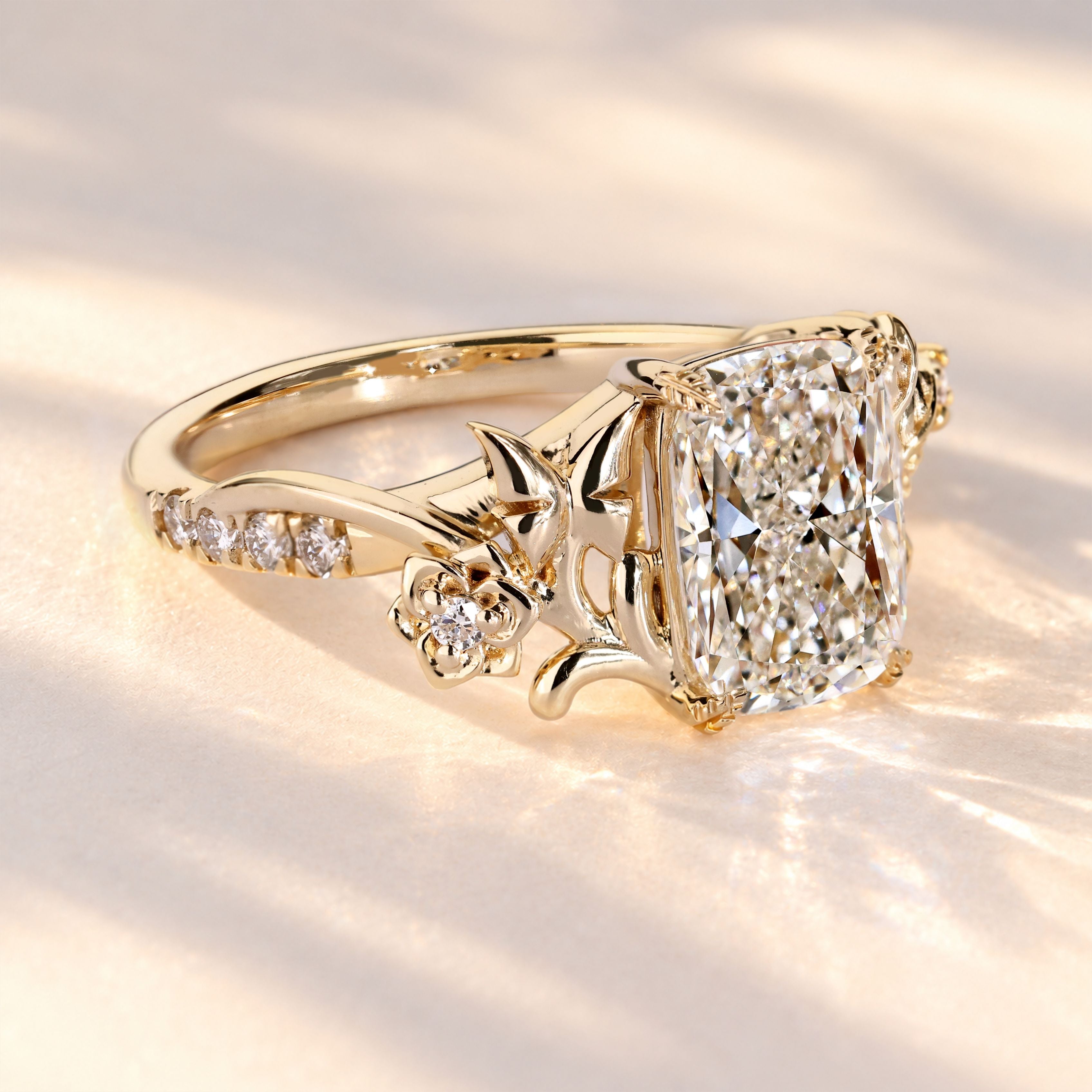 Cushion diamond ring with four leaf style prongs.

