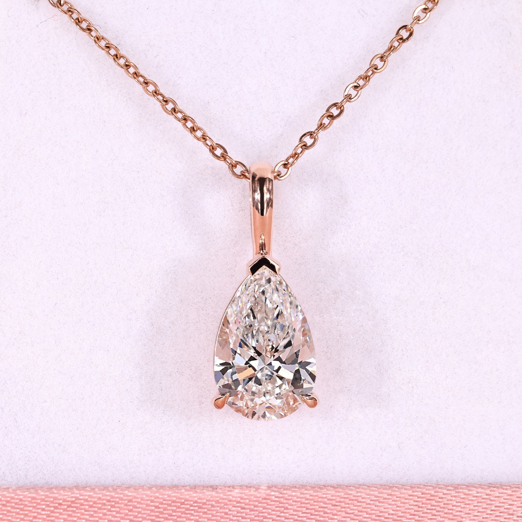 Pear diamond pendant with solitaire diamond pendant.