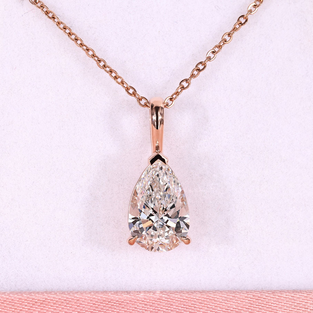 Pear diamond pendant with solitaire diamond pendant.