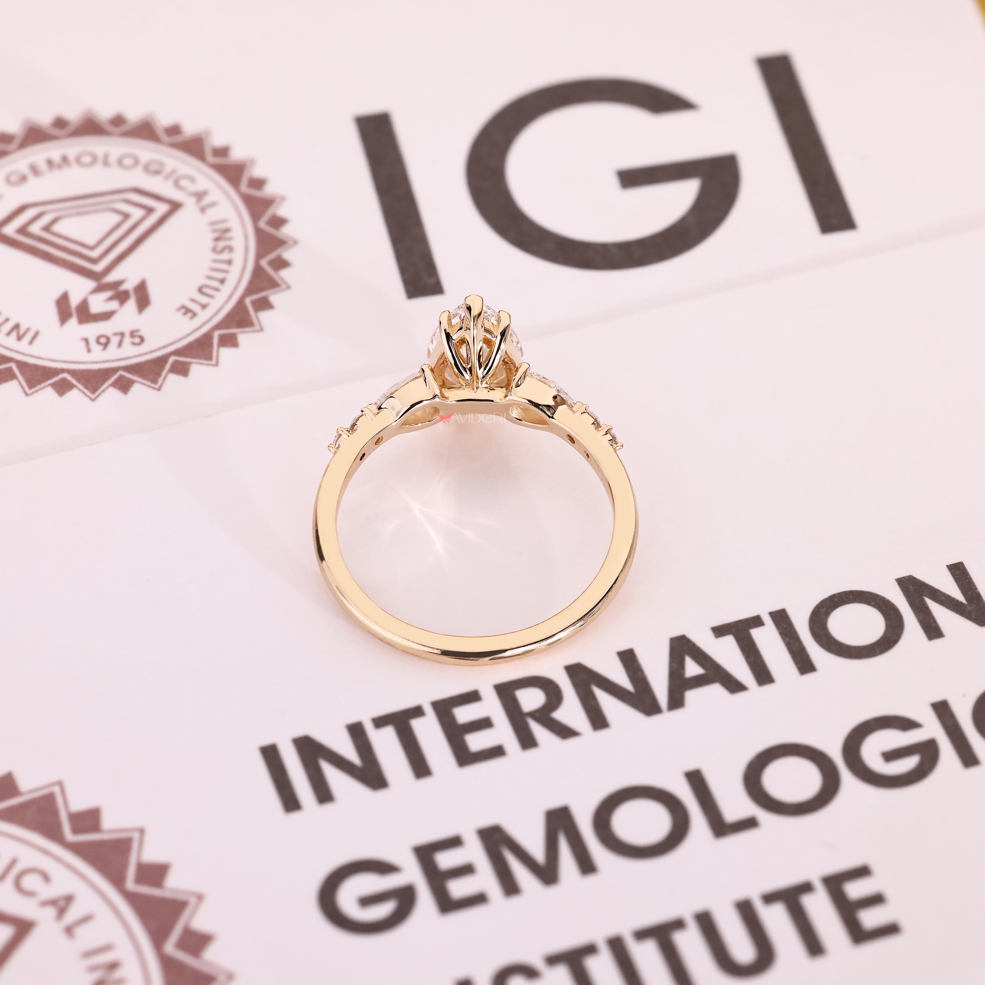 IGI certified pear ring with round and pear accents

