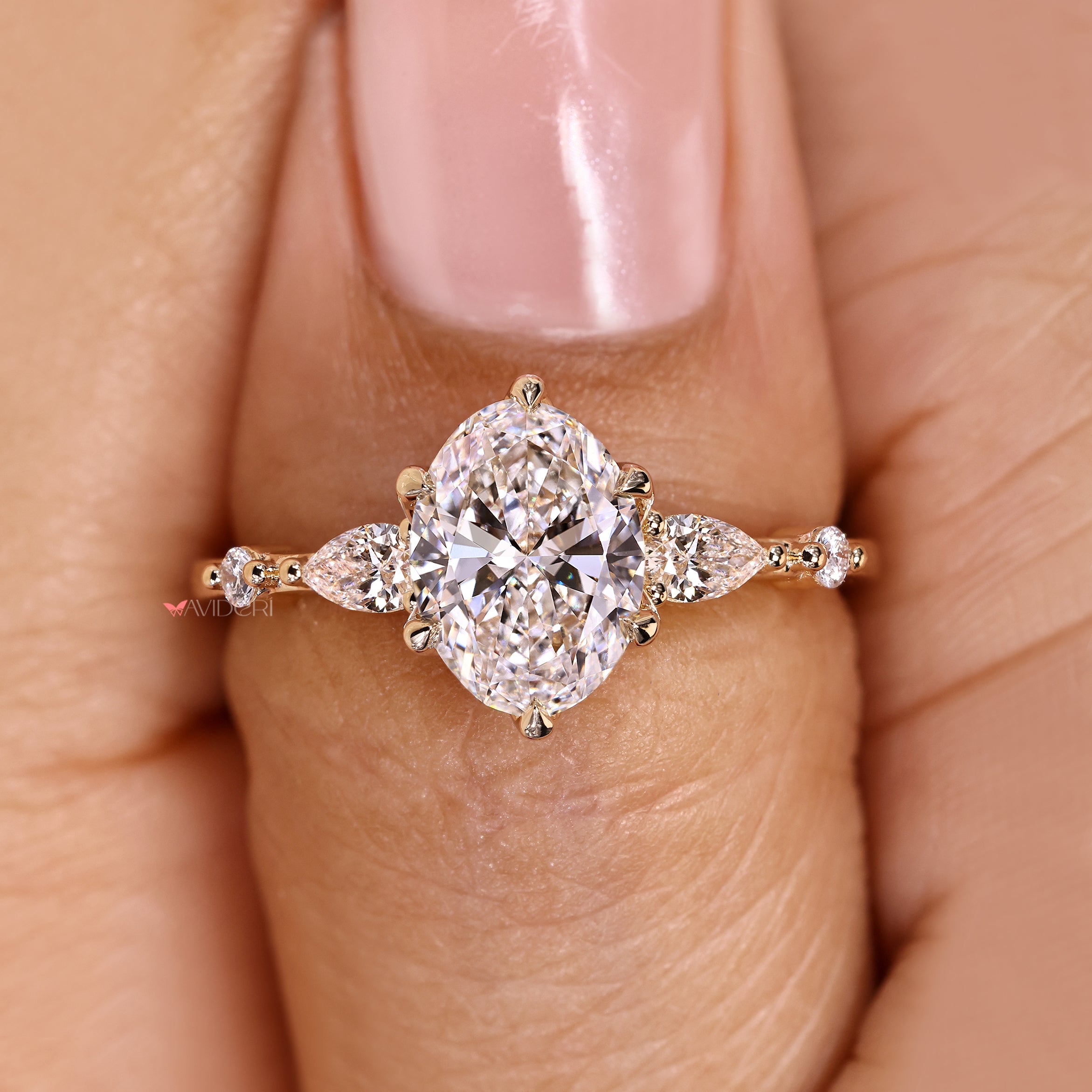 Five stone oval ring with side stone accents.
