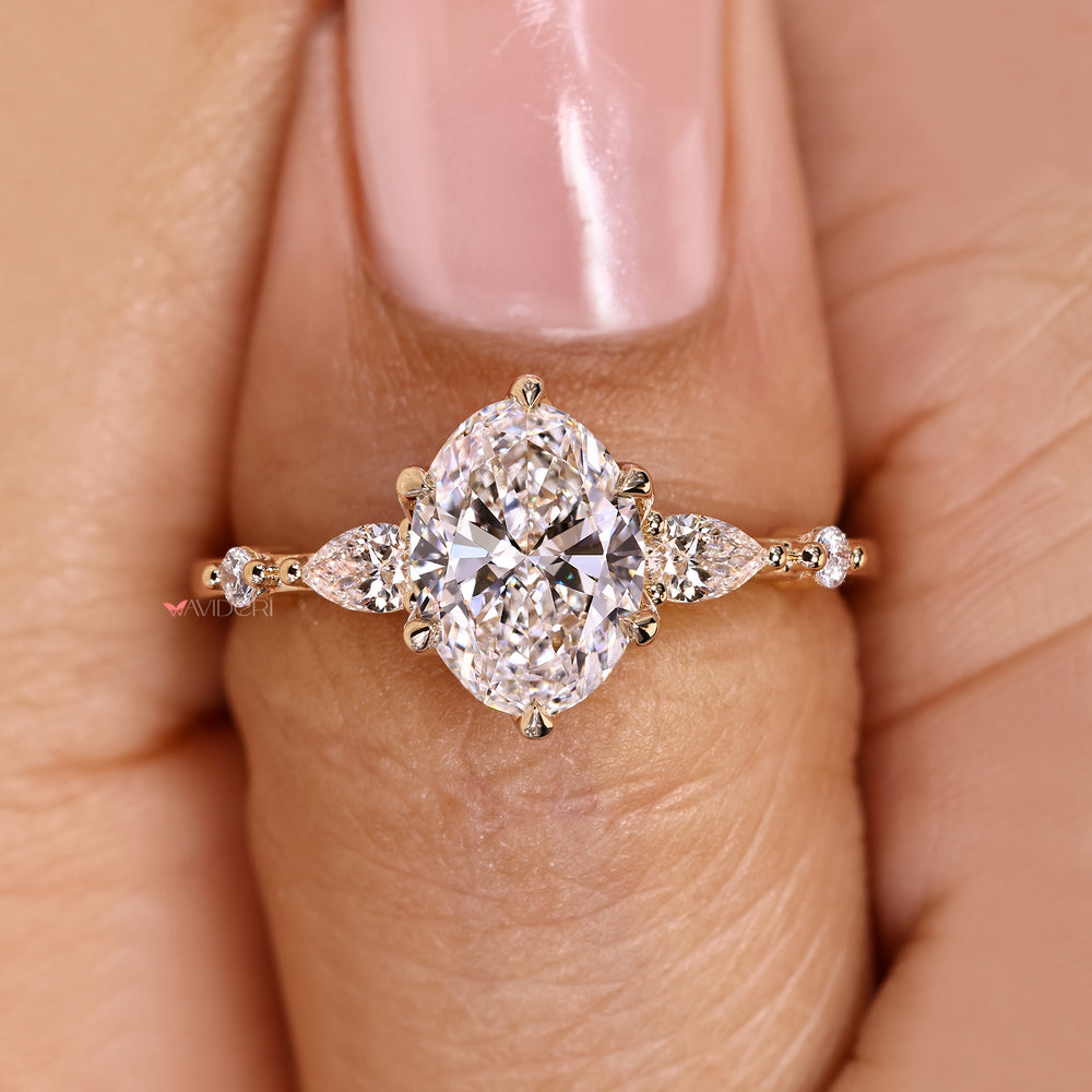 Five stone oval ring with side stone accents.
