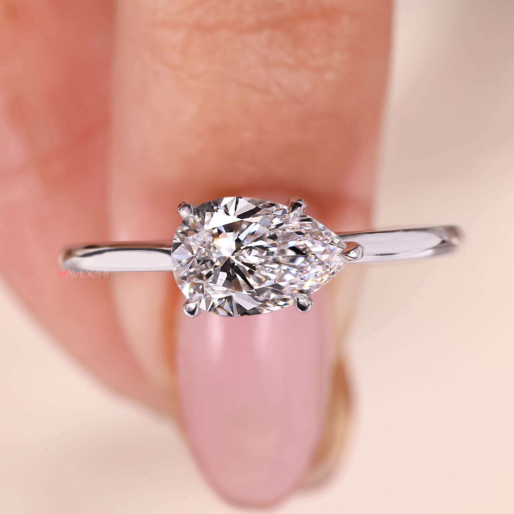 East West Setting Ring featuring a pear-shaped diamond for a contemporary look.