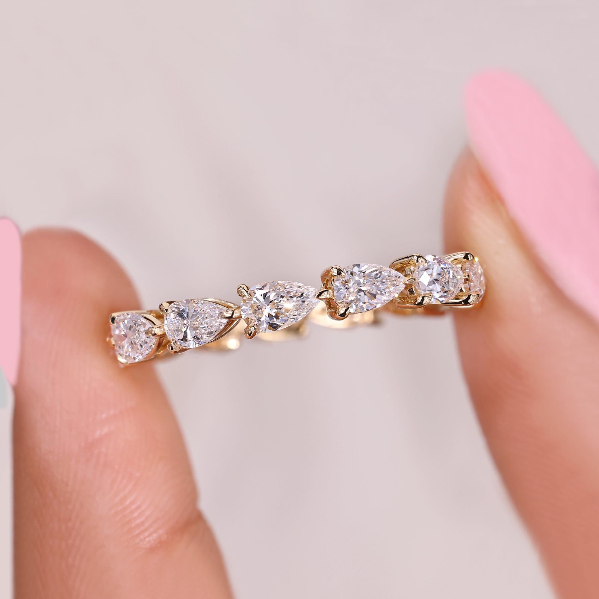 Pear cut diamond eternity band with elegant prong setting.