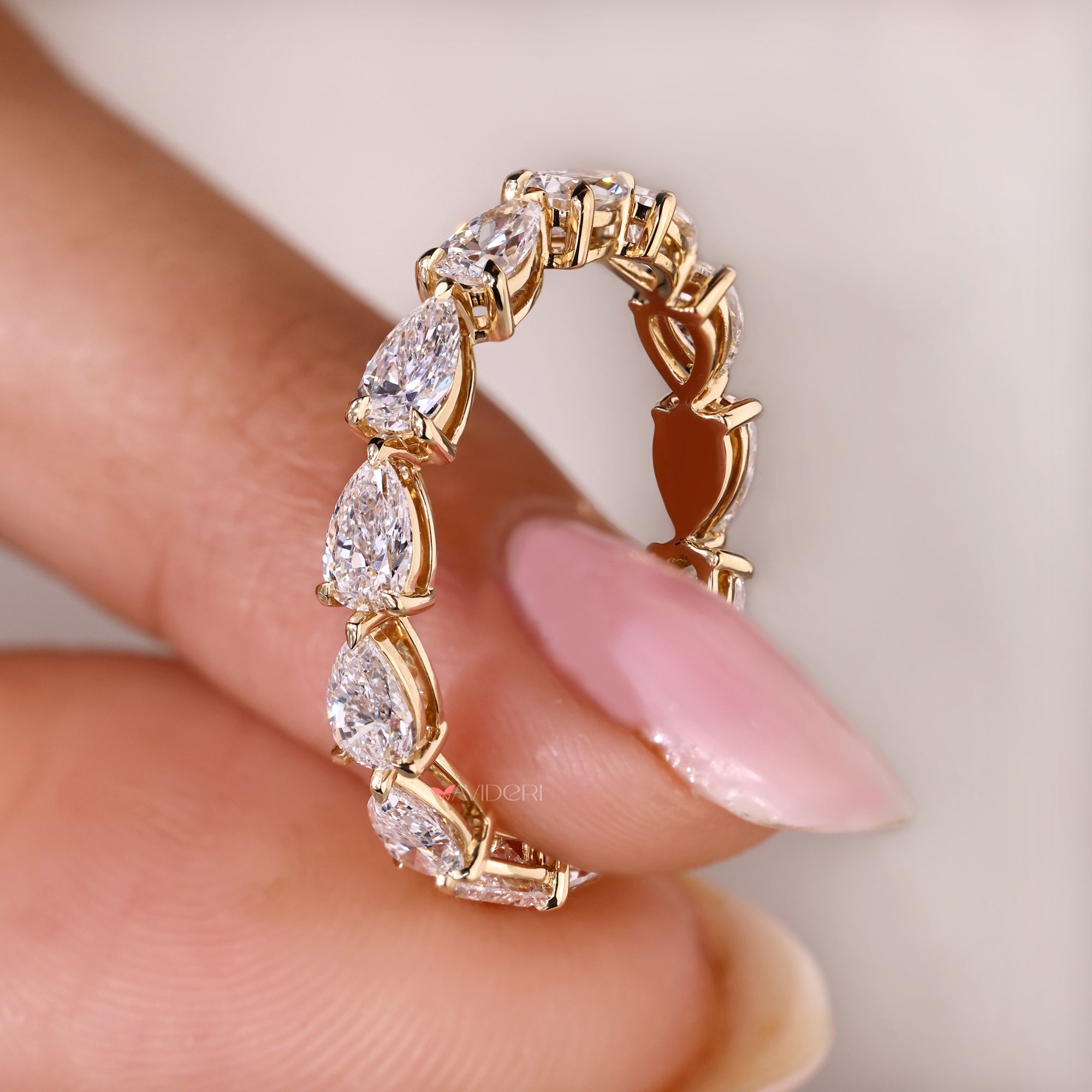 Lab grown pear cut diamond eternity band ring.
