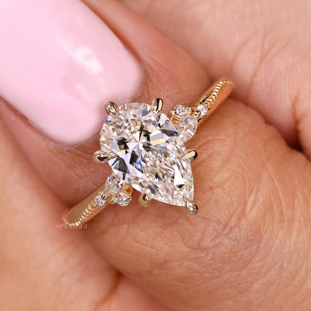 Handmade pear cut ring with marquise and round stones
