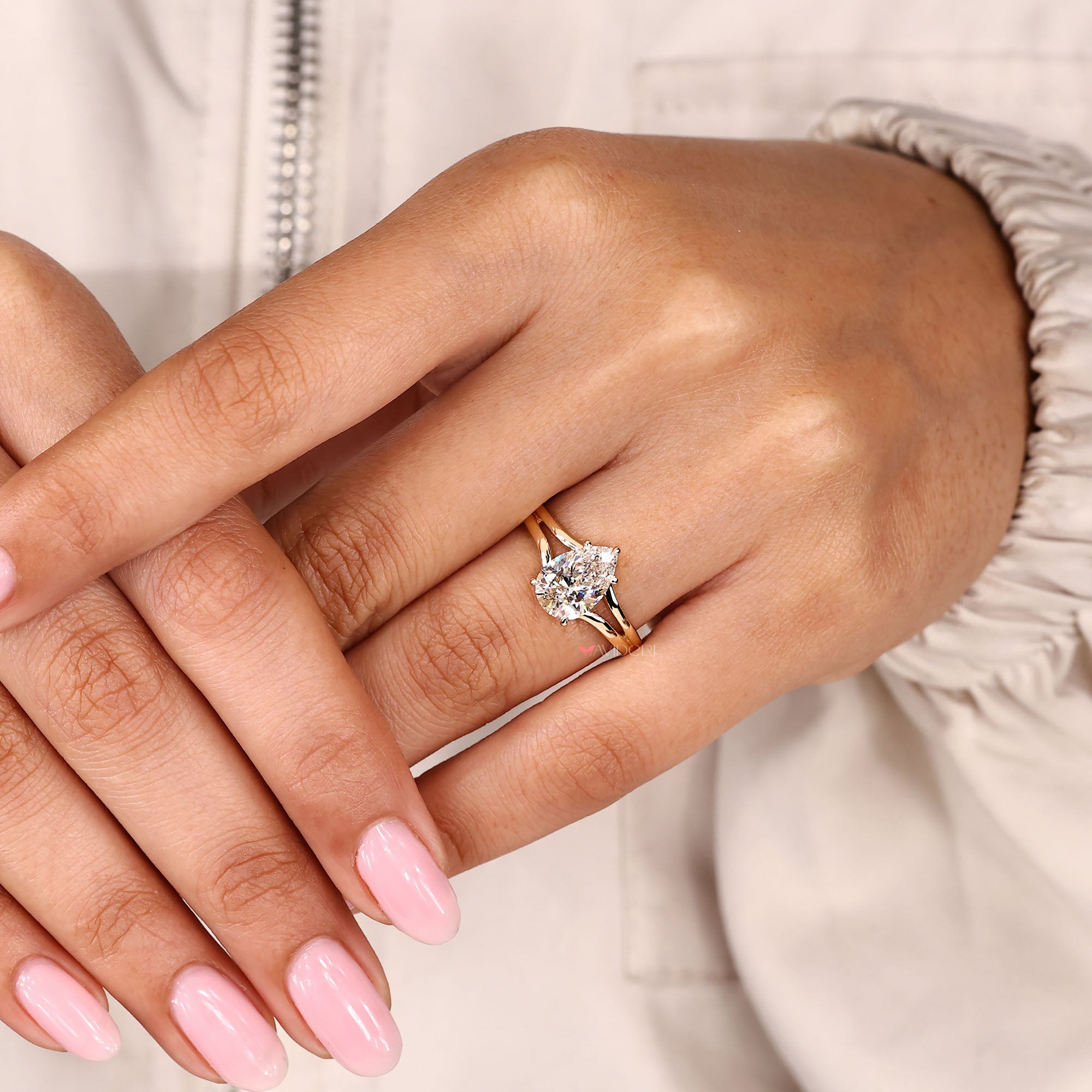 Pear cut lab grown diamond ring with hidden halo and split band.