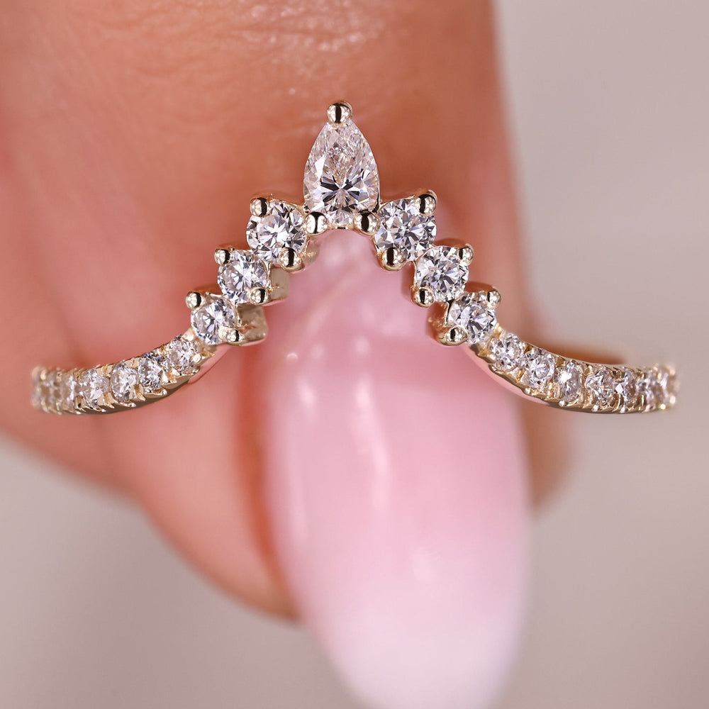 Chevron wedding band with pear cut and round diamonds.