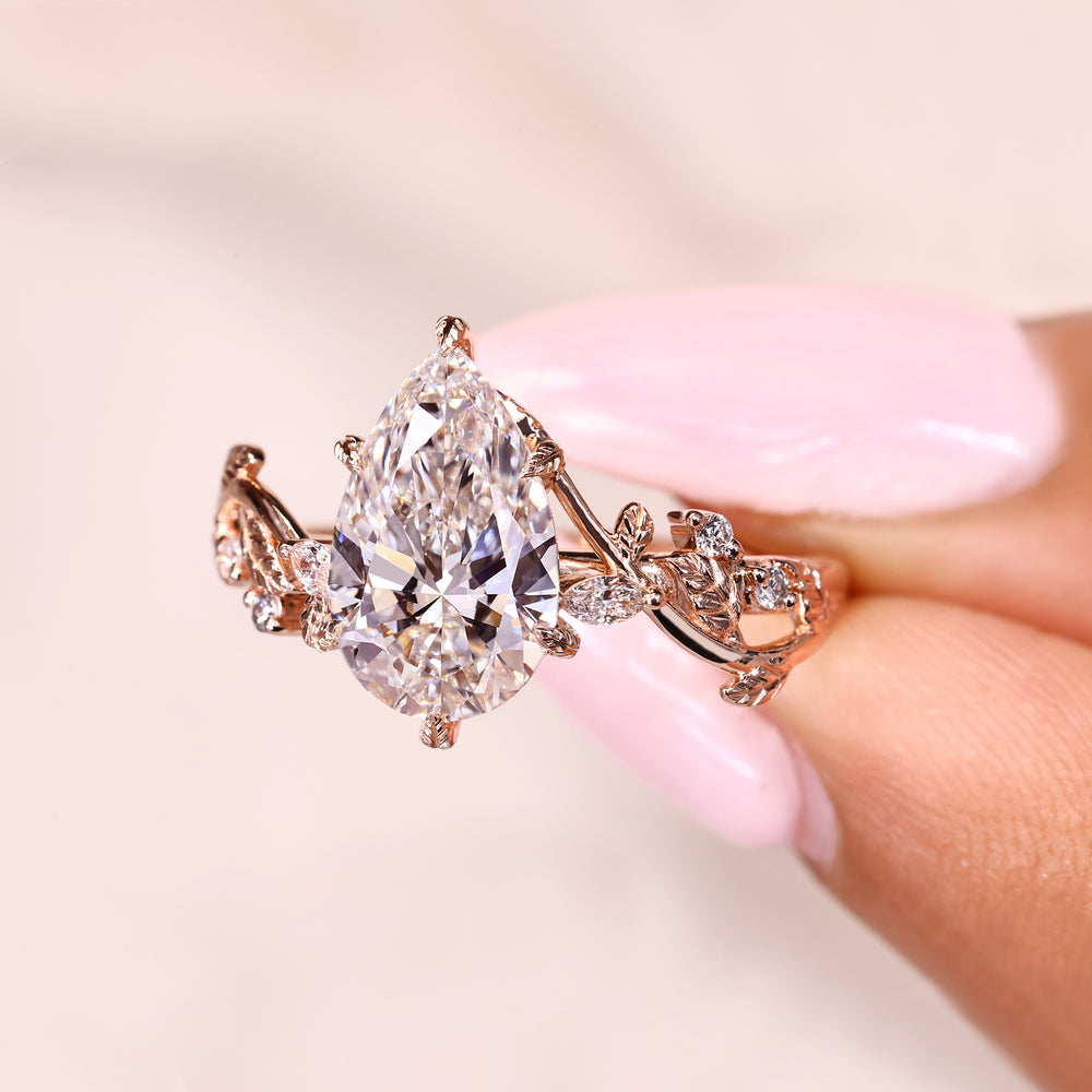 Pear shaped lab diamond ring with six leaf prongs
