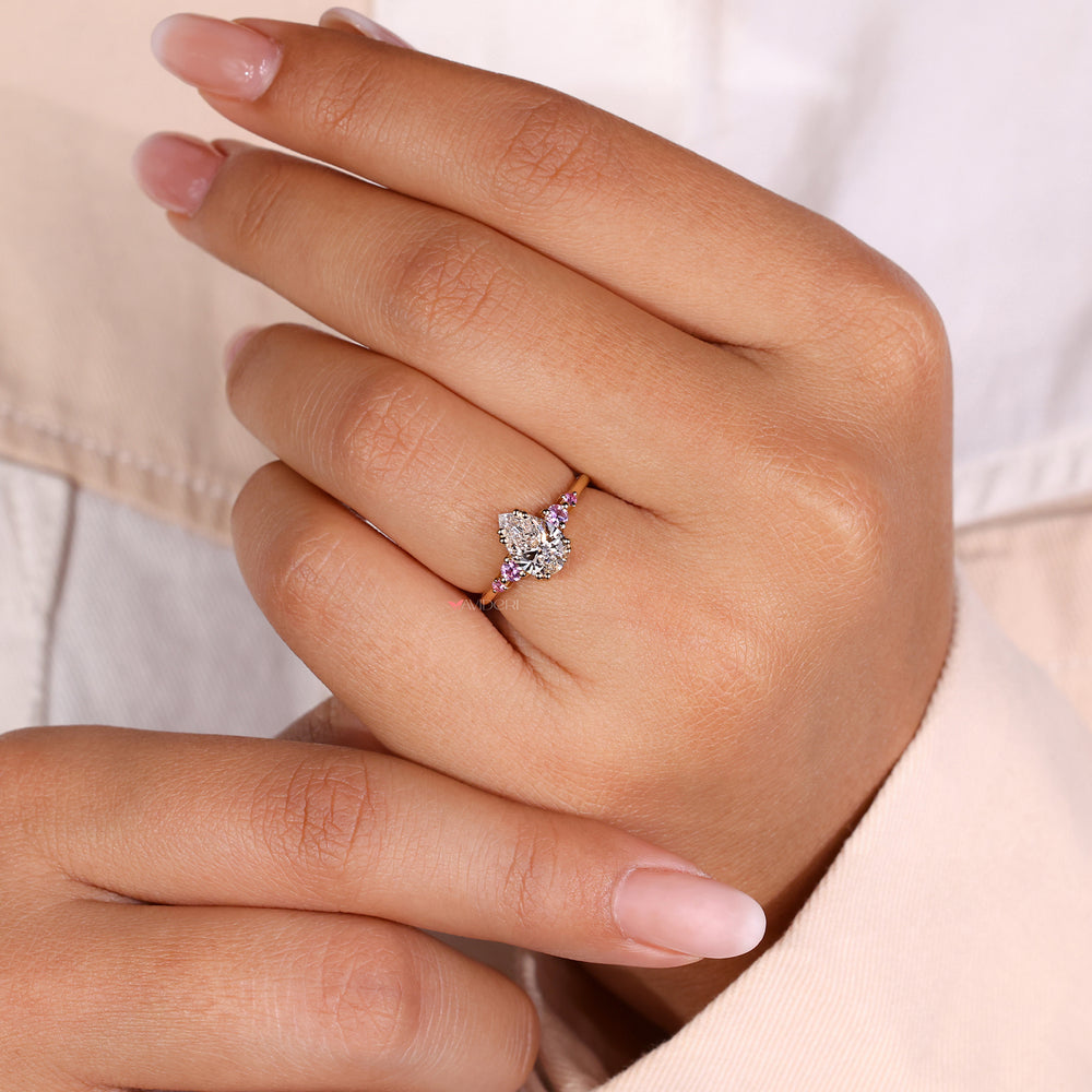 Sidestone round diamond ring featuring five sparkling stones set in a refined layout.
