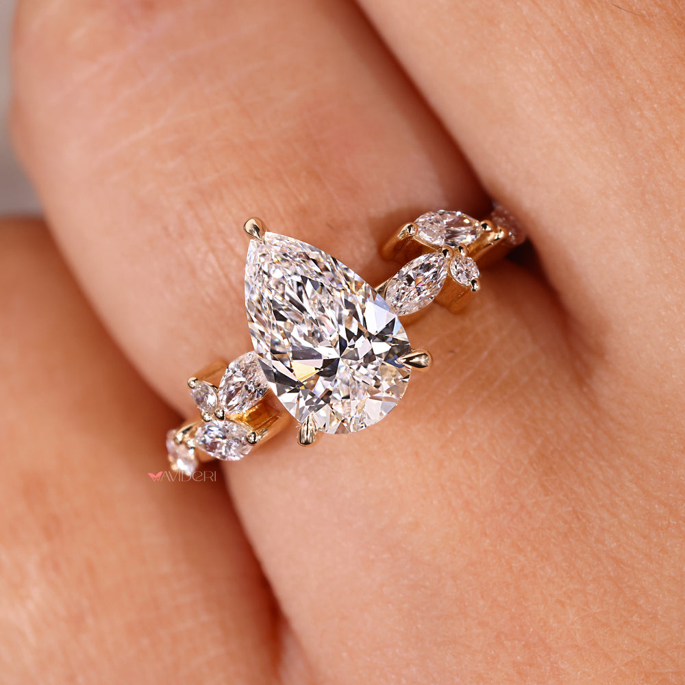 Prong setting engagement ring featuring a pear diamond and custom handmade finish.
