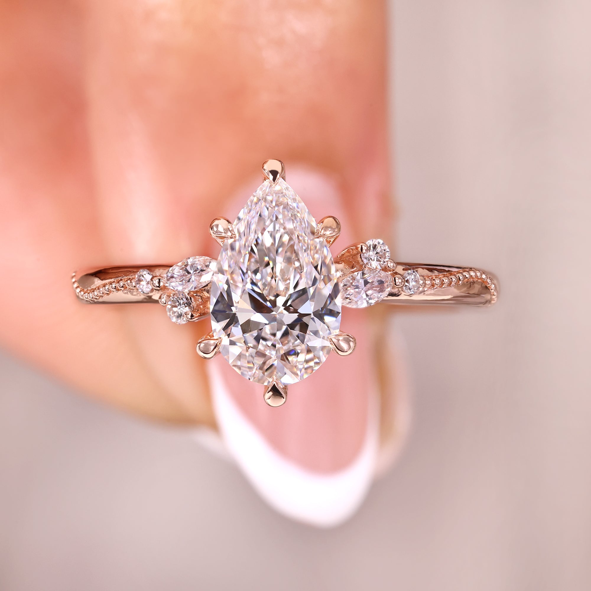 Pear diamond engagement ring with seven stone diamond ring.