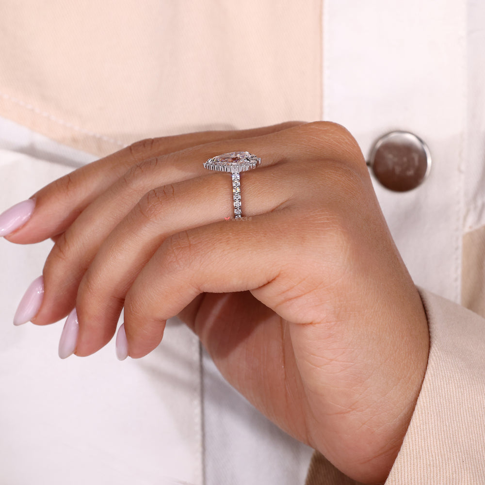 Beautiful pear cut engagement ring surrounded by a sparkling halo diamond ring.

