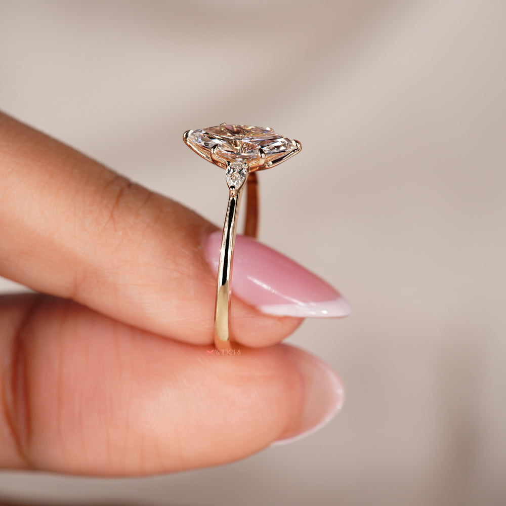 Tapered shank engagement ring featuring marquise and pear diamonds
