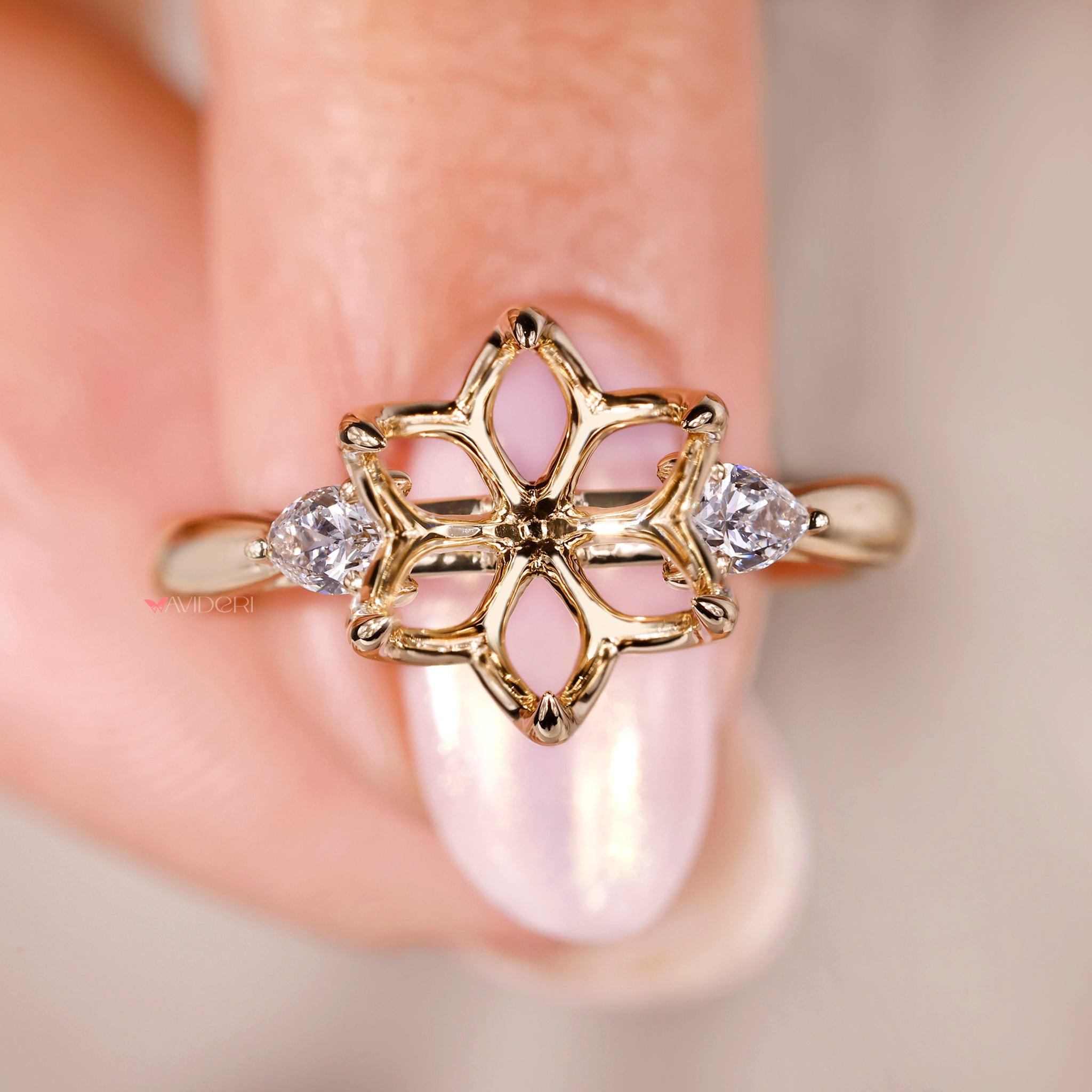 Handmade engagement ring with unique flower detailing and cathedral setting.
