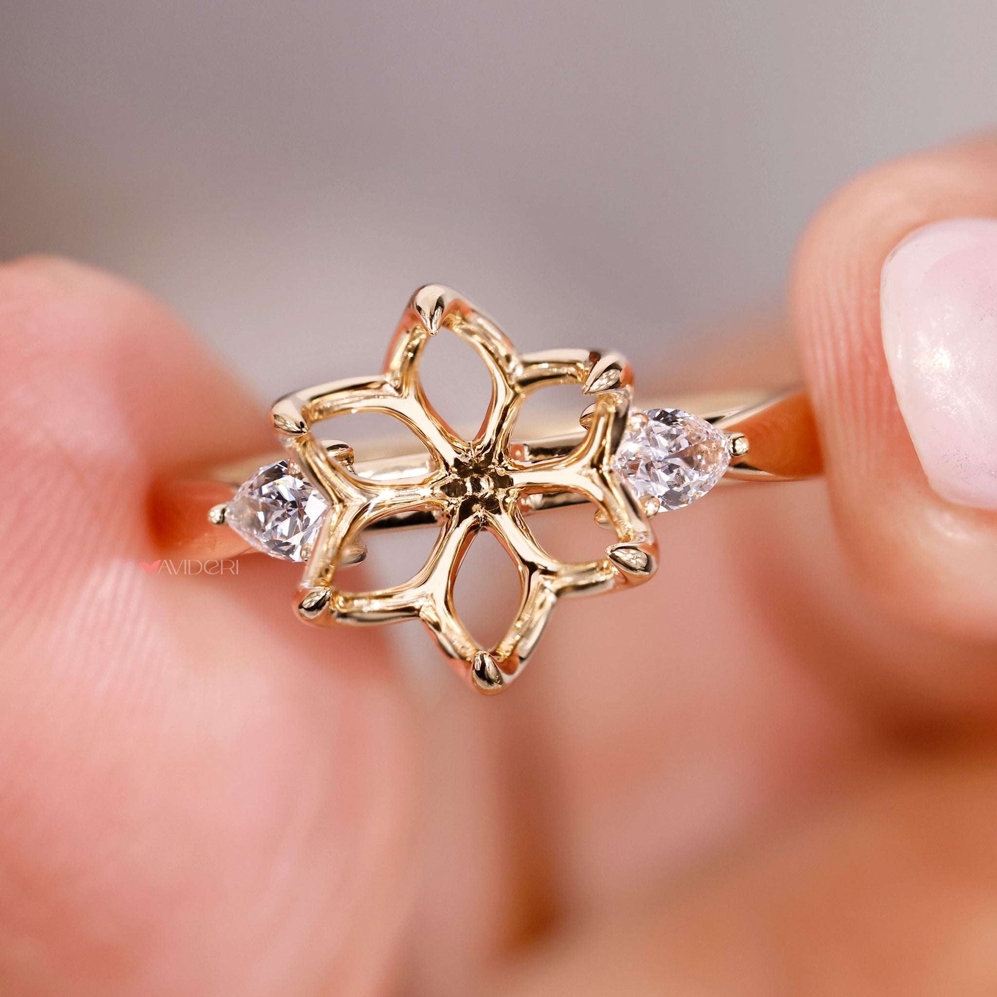 Handmade ring with 6 claw prong setting and pear side diamonds.
