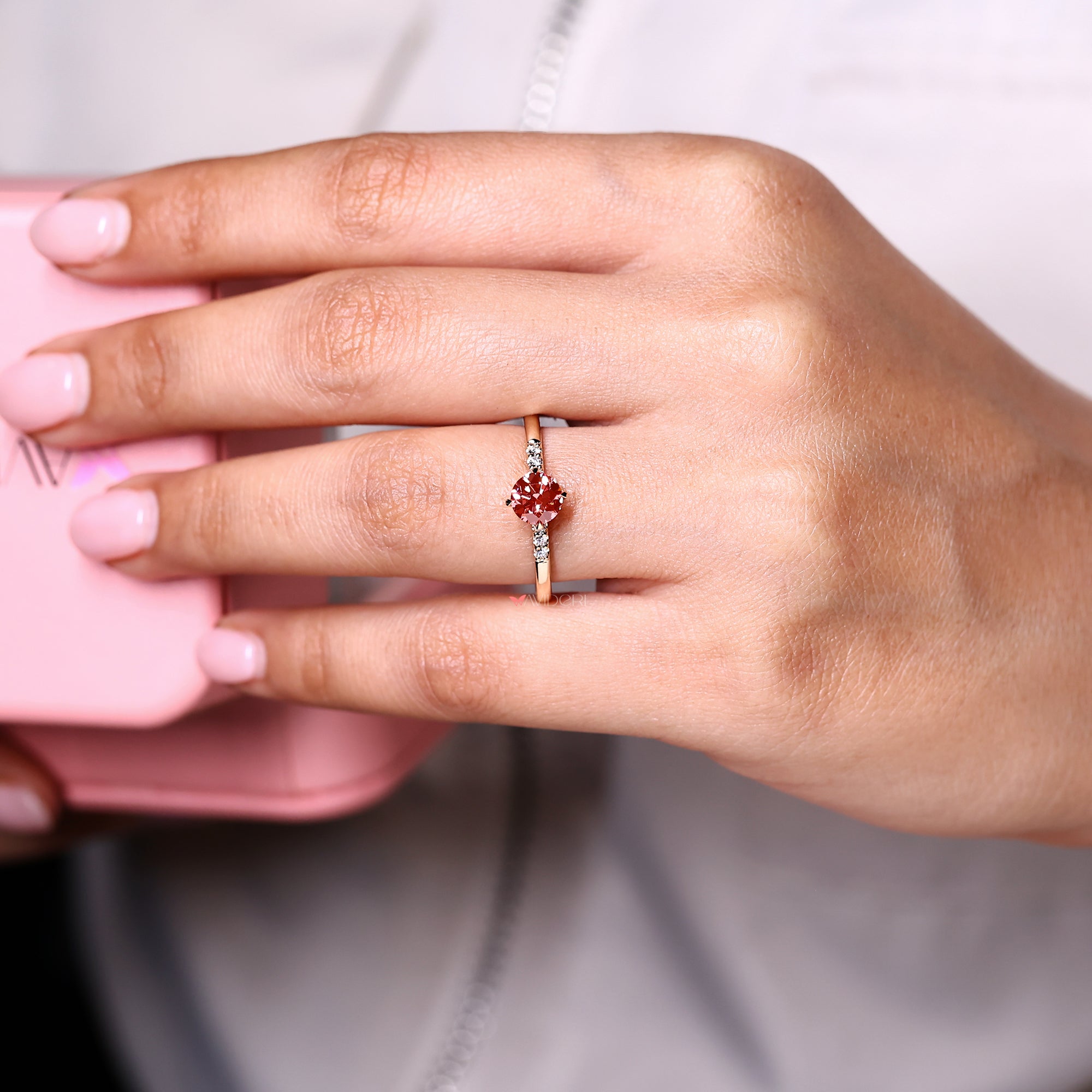 Seven stone round diamond engagement ring with compass prong setting.