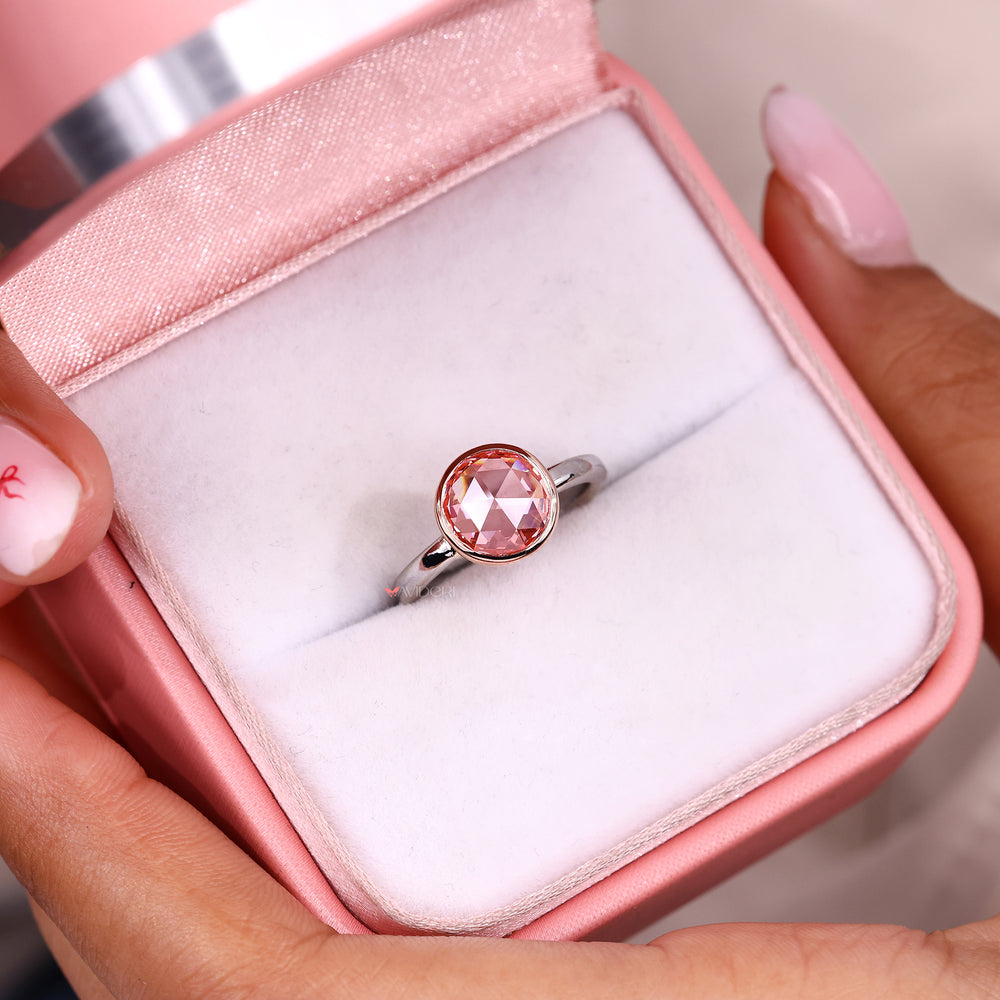 Pink sapphire accent adds a gentle touch of color.