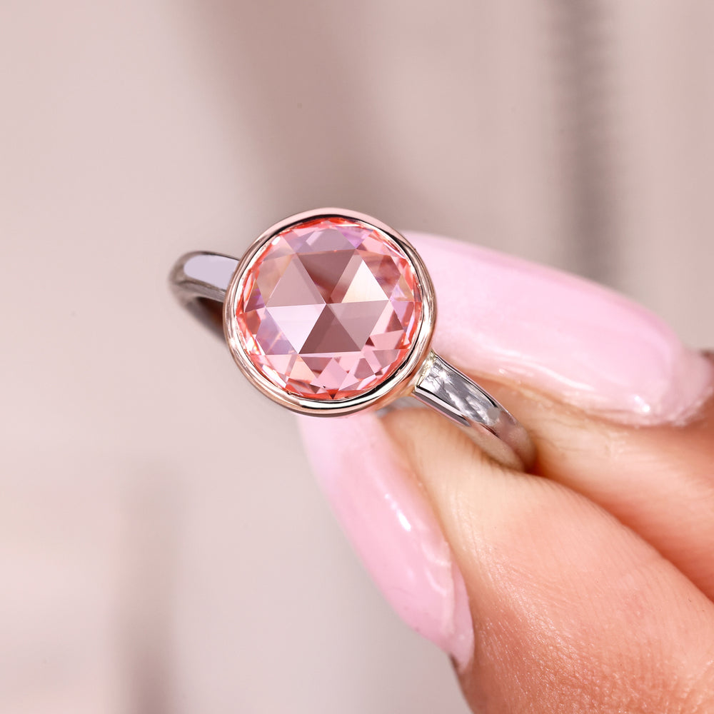 Solitaire diamond engagement ring with bezel setting style.
