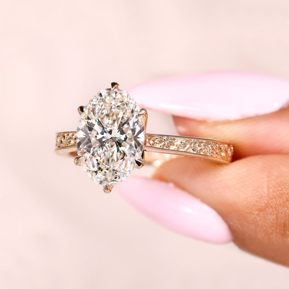 Oval diamond ring with cathedral setting and hidden halo
