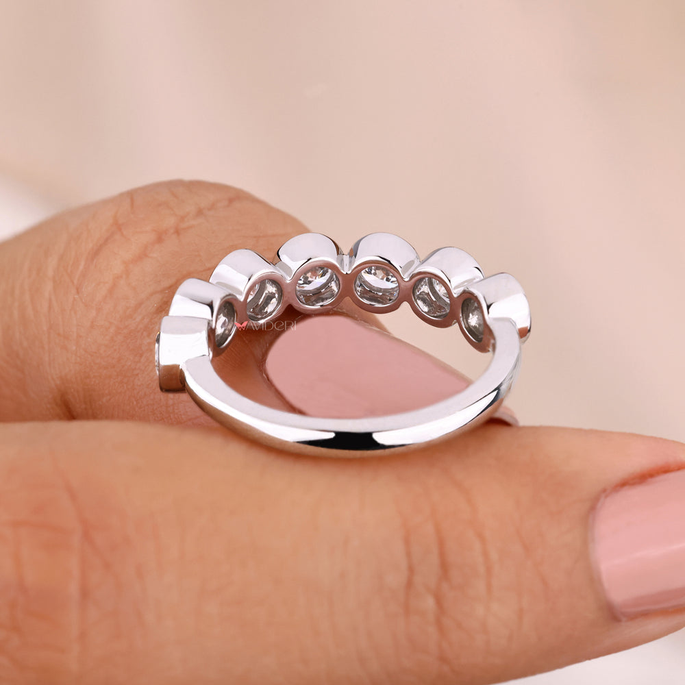 White gold diamond band featuring bezel set lab diamonds.

