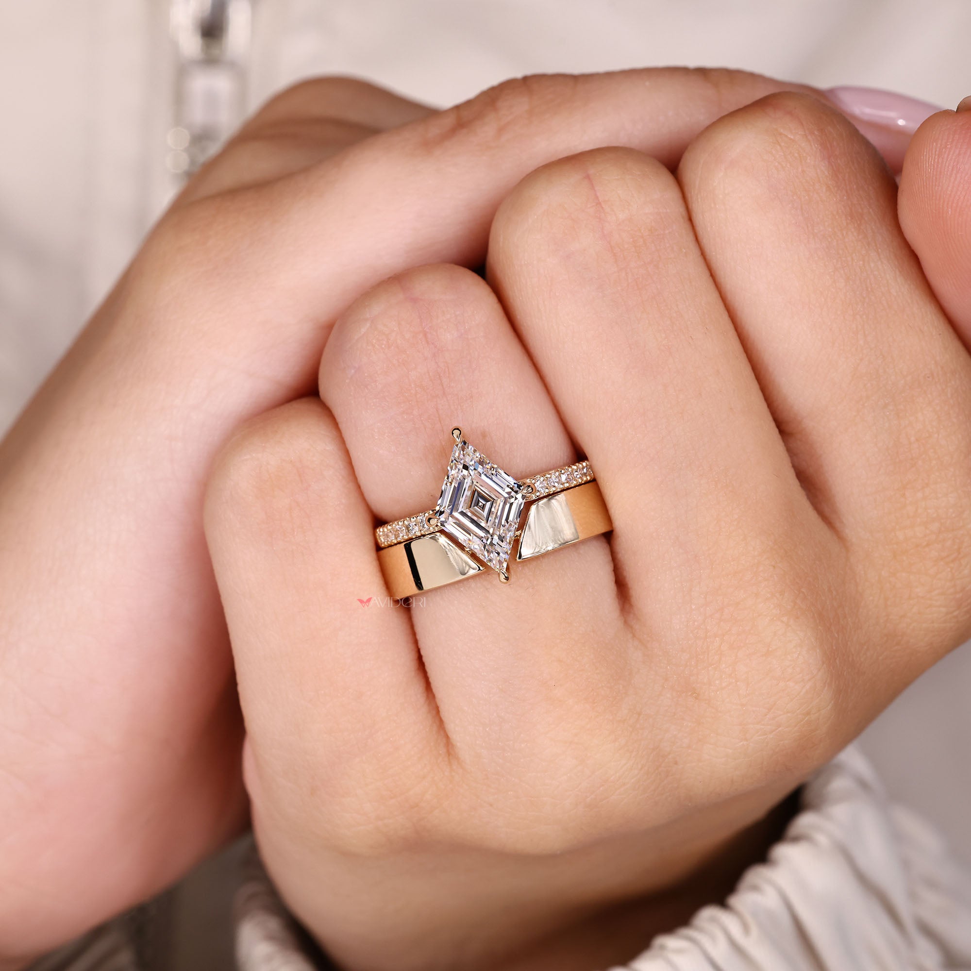 Lozenge diamond engagement ring with matching band.

