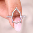 Portrait cut engagement ring with a brilliant moissanite center.