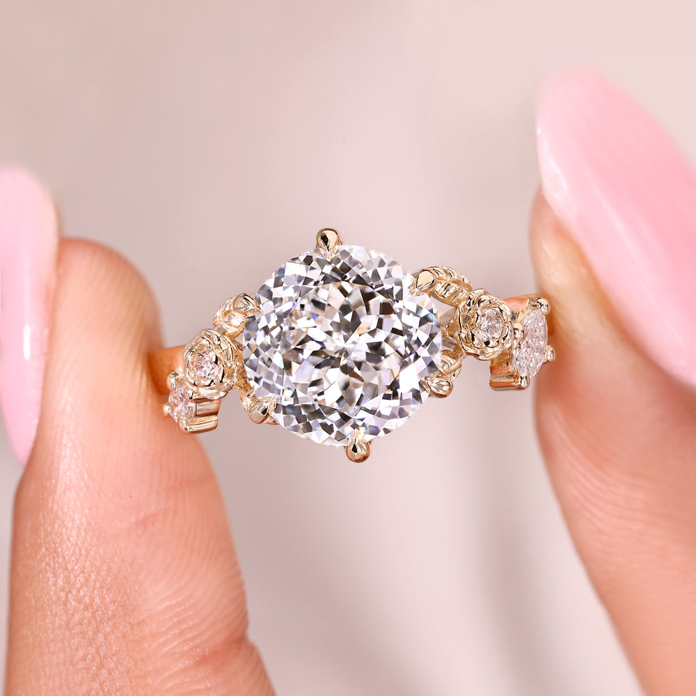 Portuguese cut diamond ring with marquise and round side stones in claw setting
