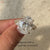 Handmade oval cut diamond ring with side stones.
