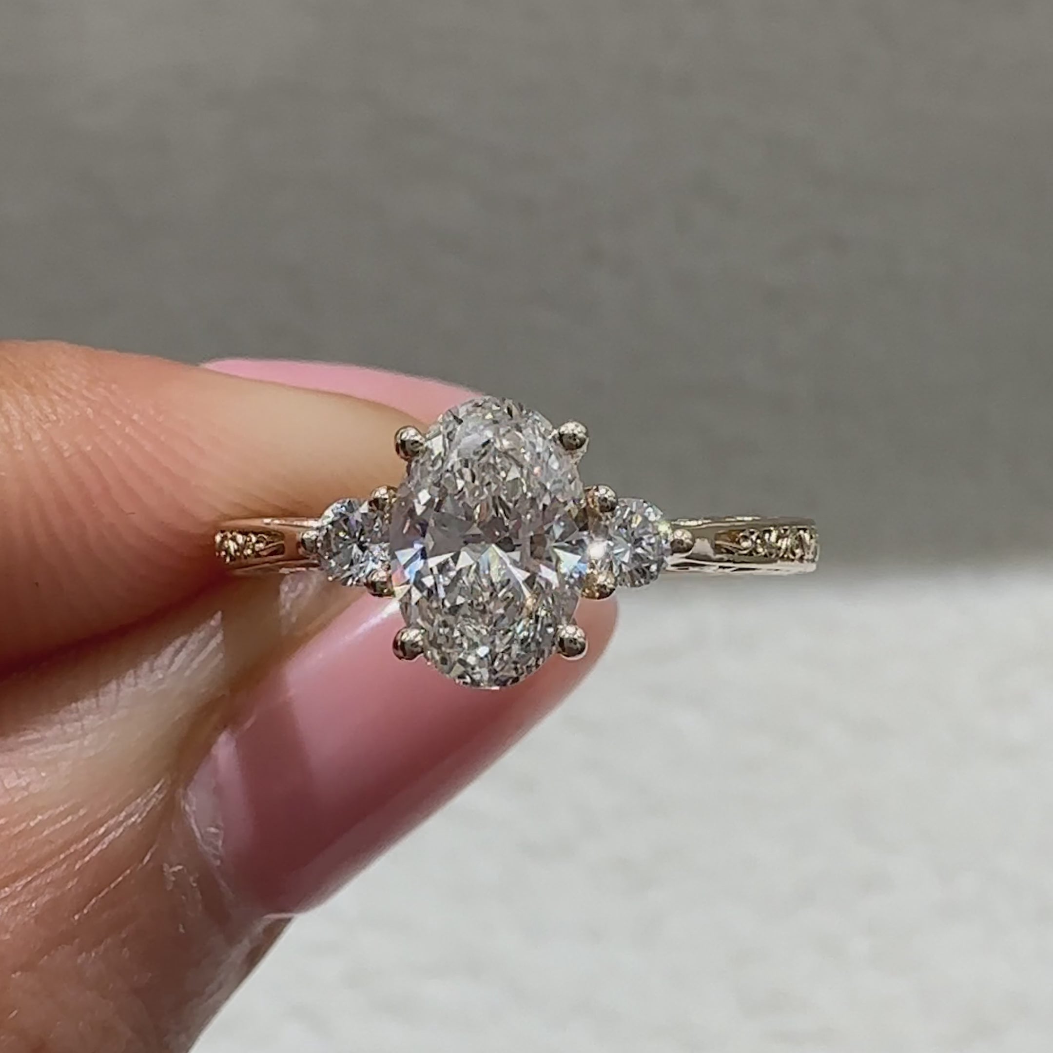 Lab grown oval ring with round side stone accents
