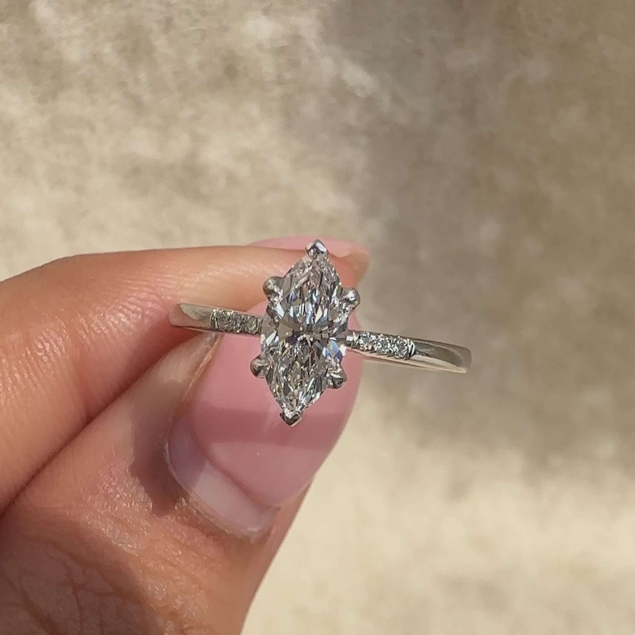 Avideri ring in white gold with marquise diamond and side stones.