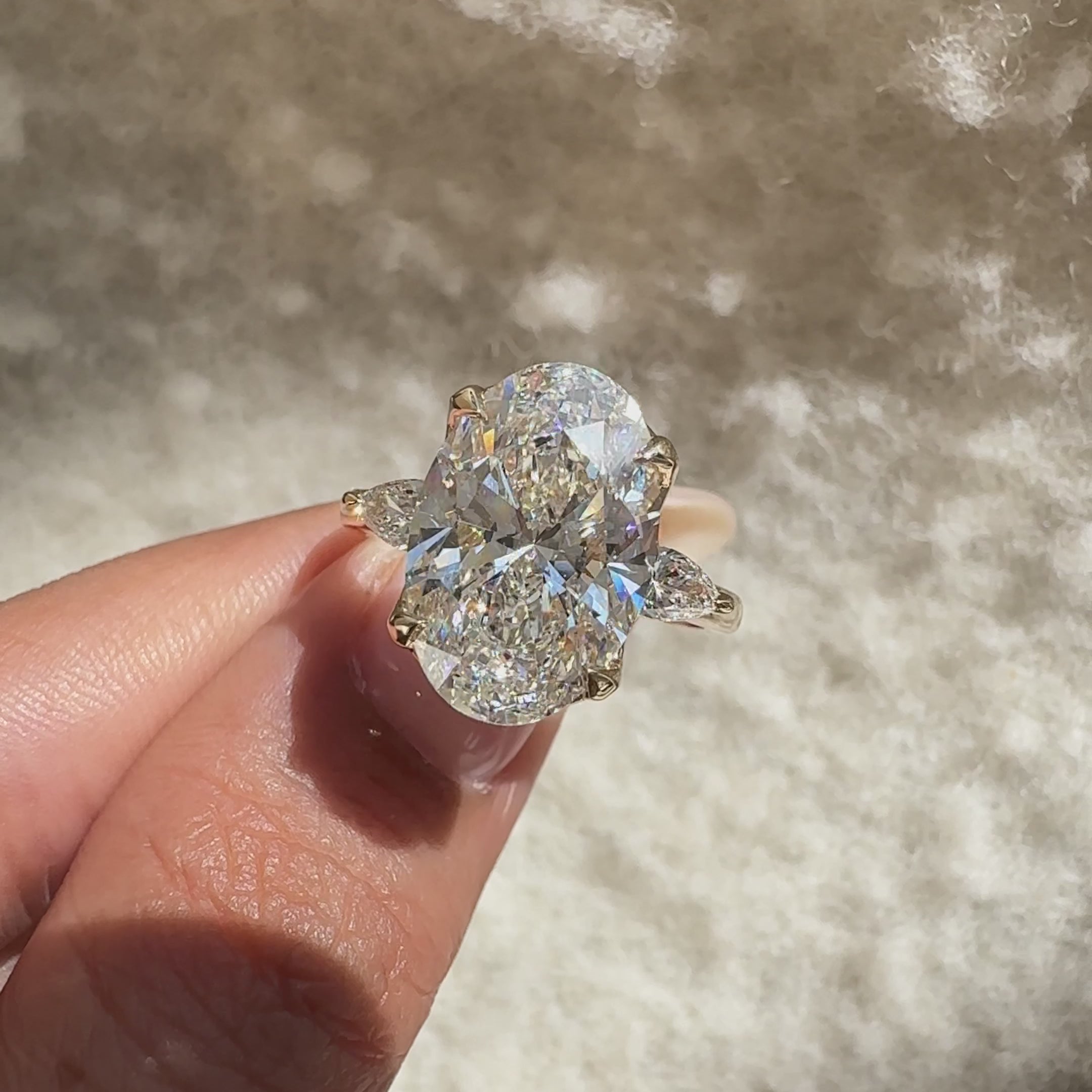Oval cut diamond ring with pear side stones.

