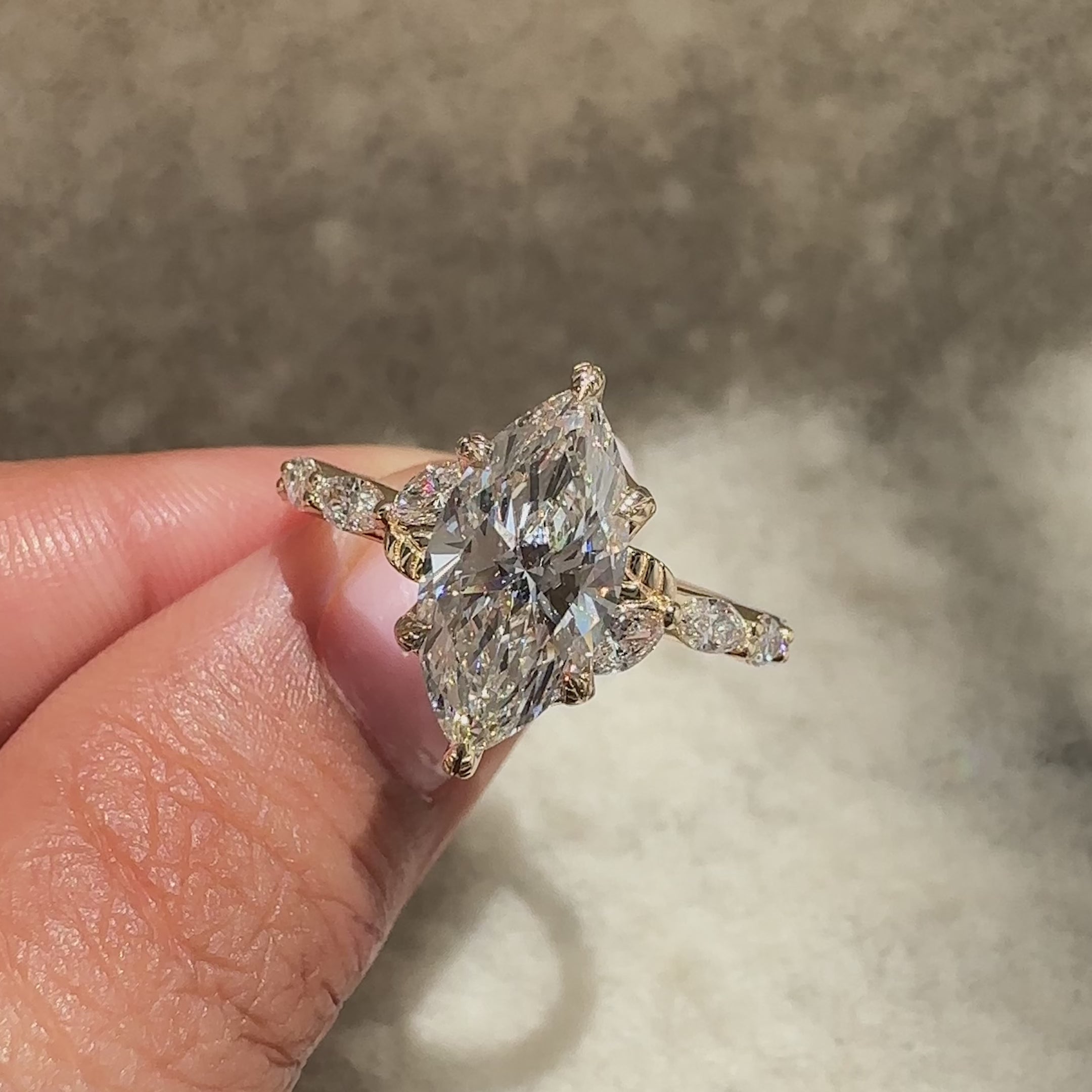 Marquise diamond ring with pave style setting.
