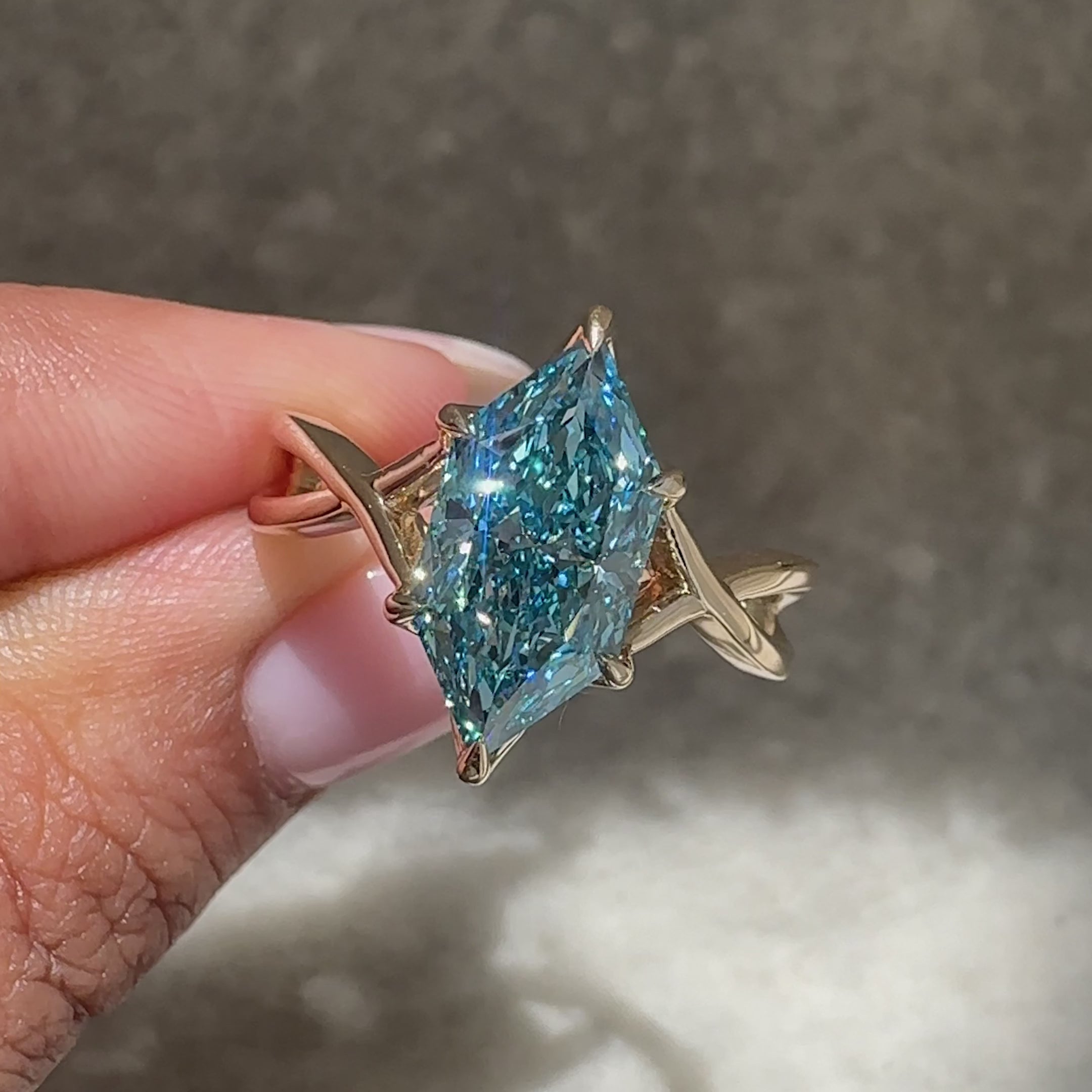 Handmade blue diamond ring with six prong.