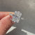 Radiant cut diamond ring with pave setting band.

