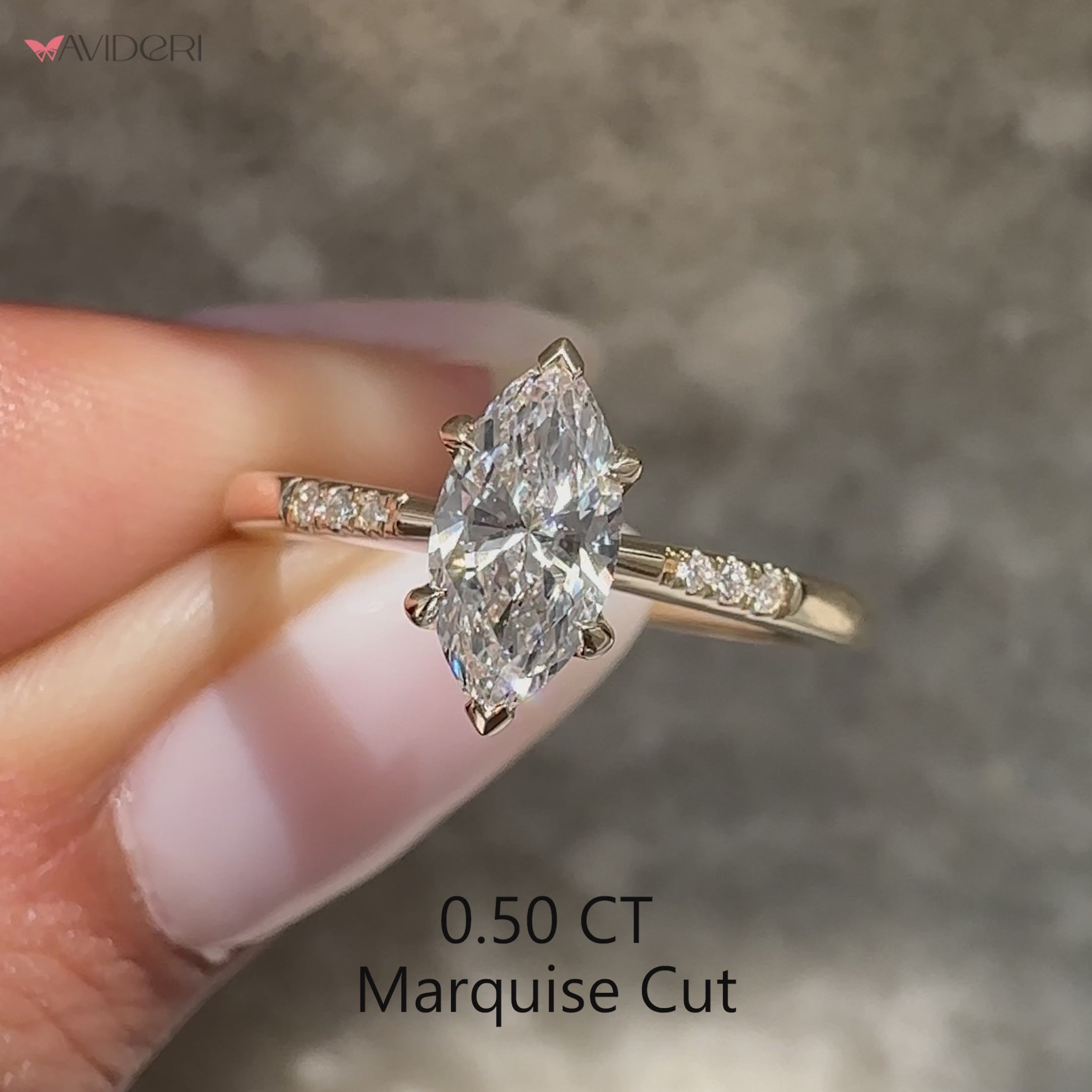 Marquise diamond ring with round diamond pave accents.
