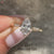 Marquise diamond ring with round diamond pave accents.
